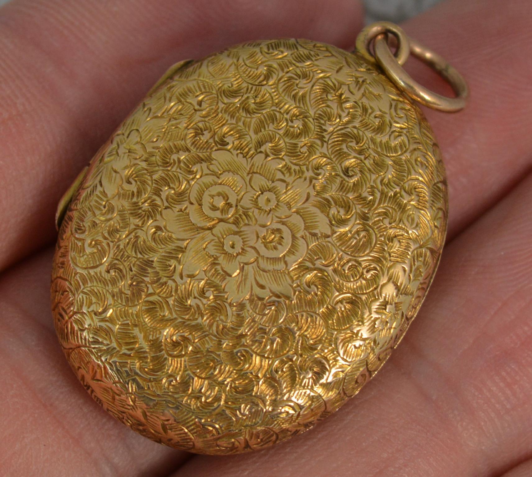 A true Victorian period pendant locket c1880.
Solid 15 carat yellow gold example.
Designed with very fine hand engraved floral pattern to each side and blank cartouche to the centre. 
Suitable for four photographs.

CONDITION ; Excellent. Very crisp