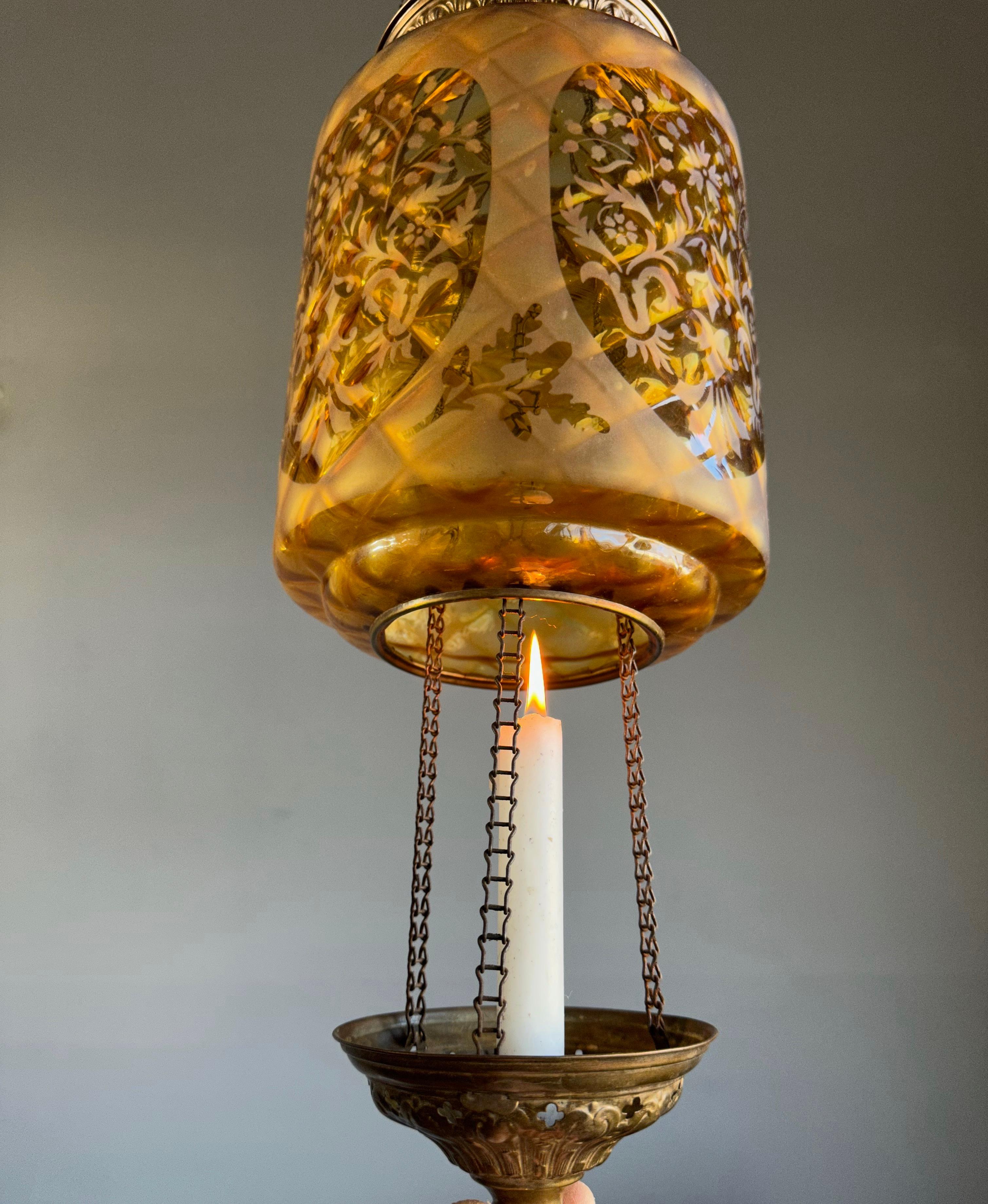 Graceful and all handcrafted antique light fixture.

This early Arts & Crafts era pendant has an aesthetic beauty that you don't find anymore in this day and age. It has the most pleasing to the eye shape and amber color and the handcrafted brass