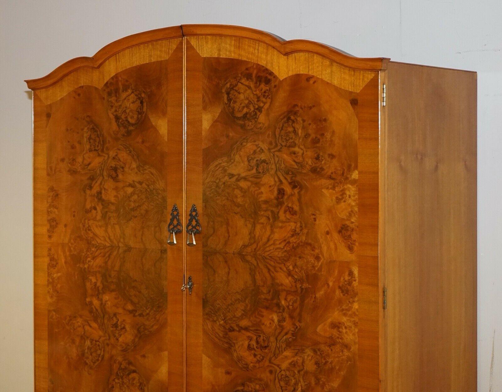 We are delighted to offer for sale this lovely vintage burr walnut double door wardrobe.

This piece has such lovely Walnut Burrs on front of the opening doors of the wardrobe, as you open you will be able to see a top-right shelf and a hanging