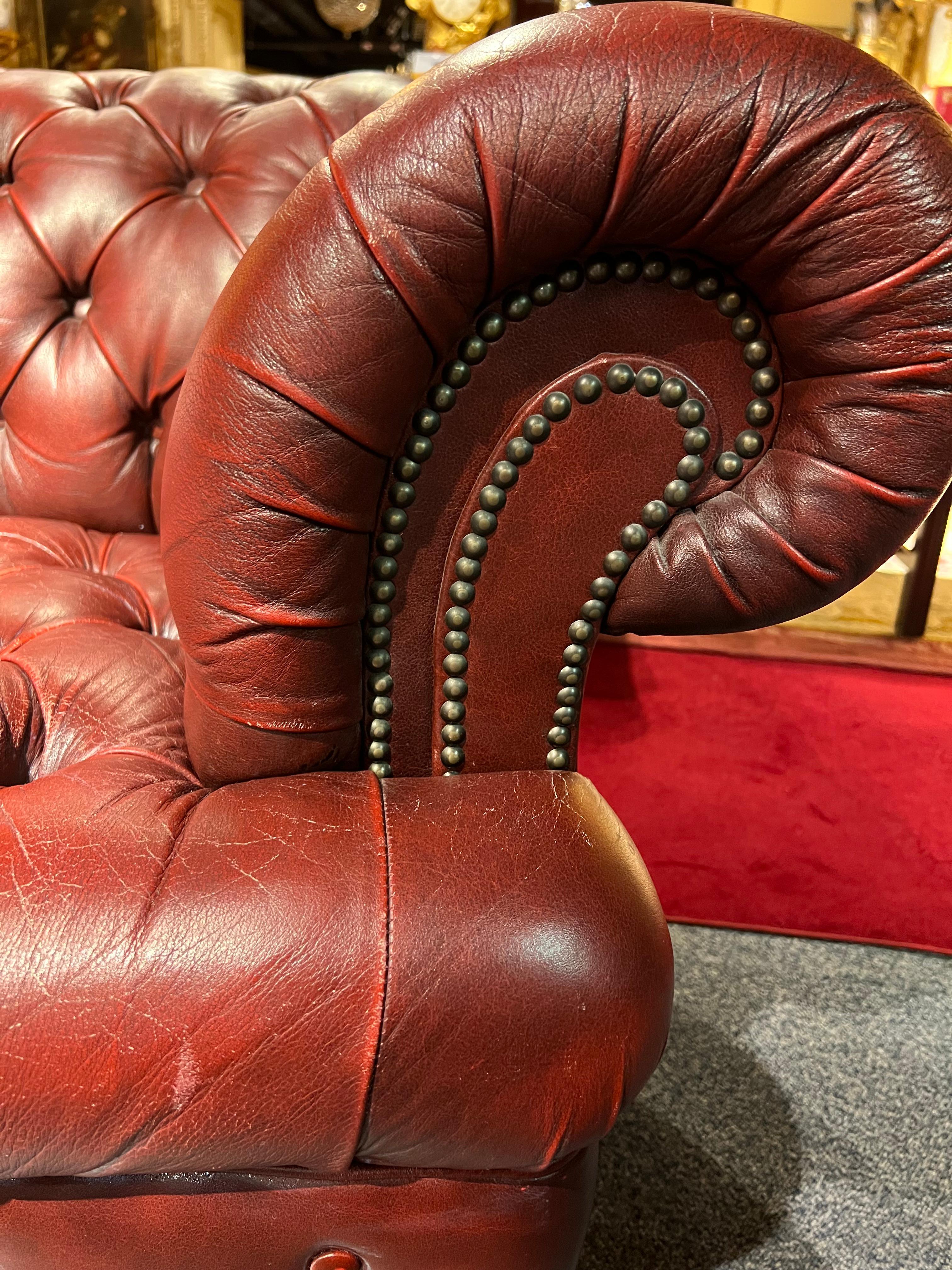 red leather tufted sofa