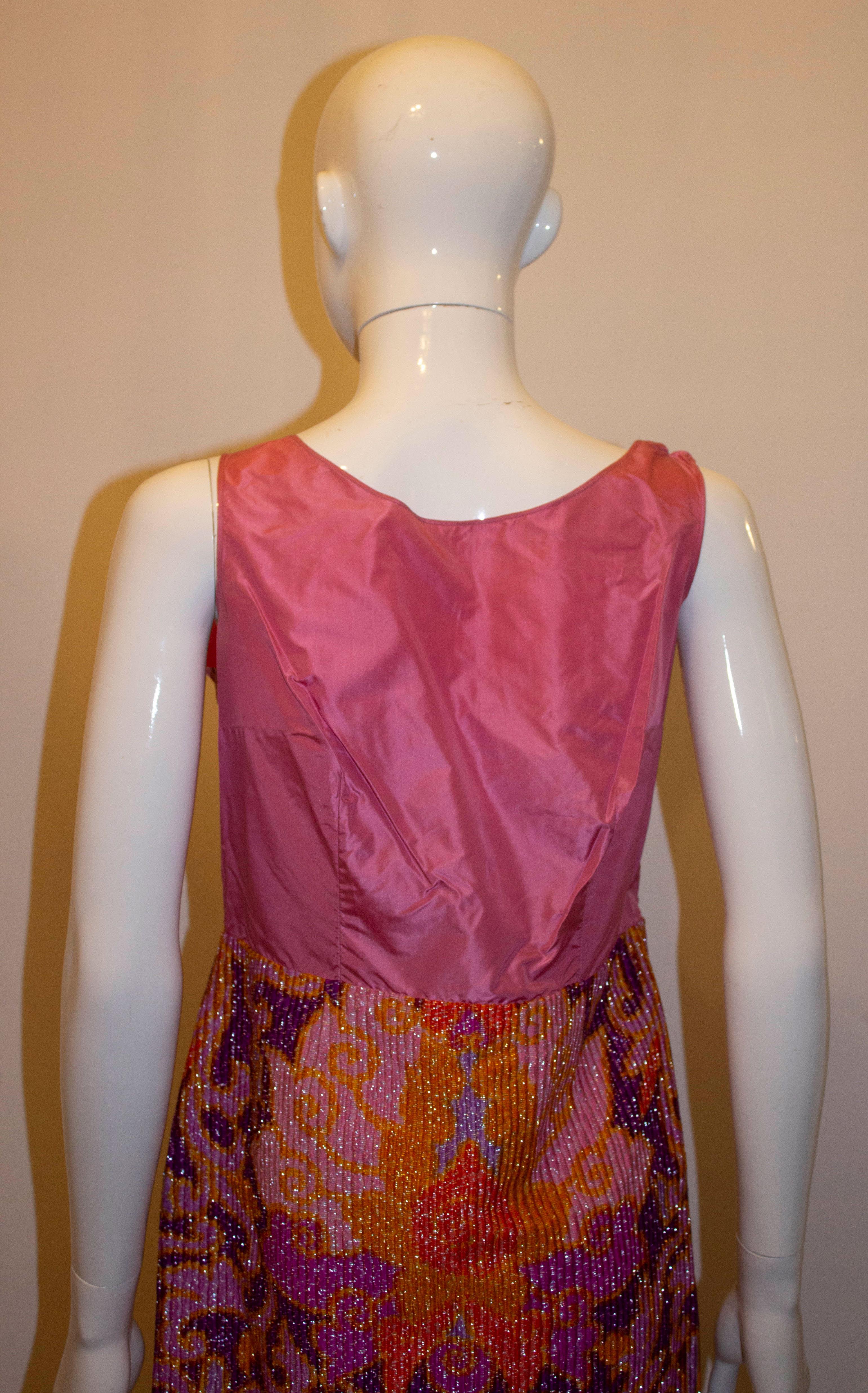 A real vintage headturner by Harry B Popper. In a wonderful colour combination of purple , orange and yellow. The 'under dress ' has a side zip opening, and the 'coat ' a slit at the front and back. There is a side slit of 12''  