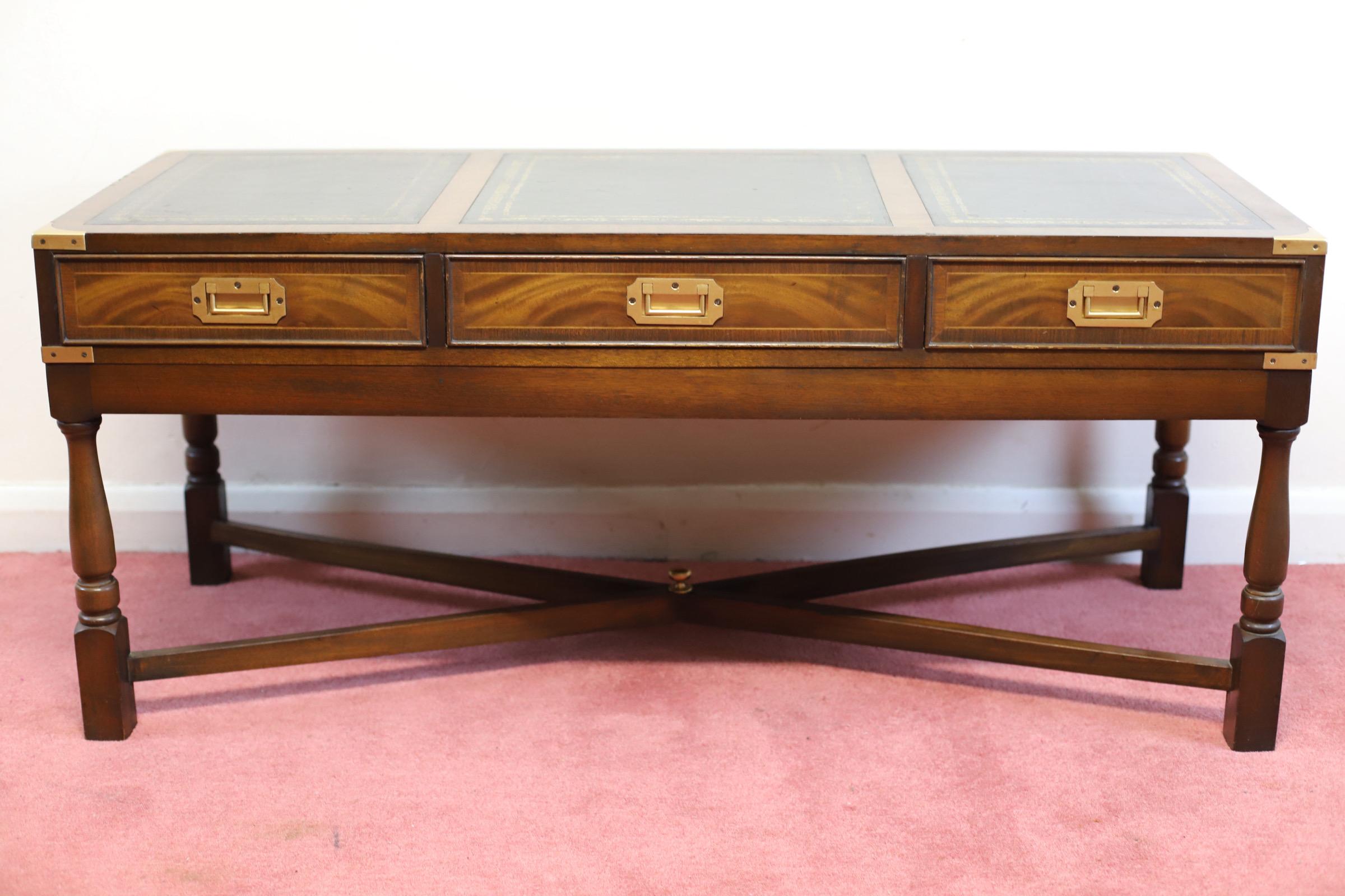 We delight to offer for sale this Lovely Campaign Style mahogany &brass Coffee Table with black leather top separated in three parts , three opening drawers with inset brass handles , brass corner straps, in excellent original condition. Circa 1960