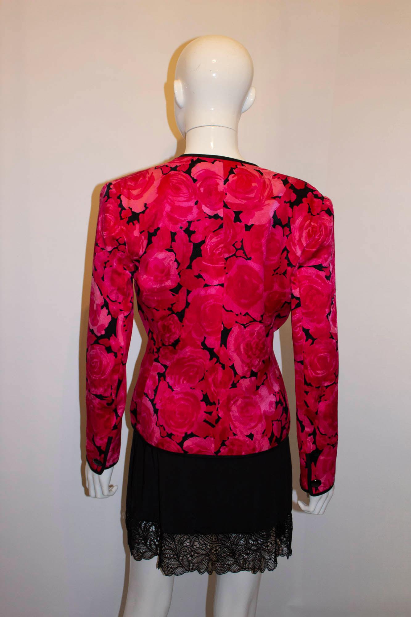 A headturning vintage silk jacket by Andrea Odicini. In a beautiful pink silk with floral design and black trim, the jacket is made so it can be reversible with the black silk inside. The jacket has a v neckline and great tailoring. Measurements:
