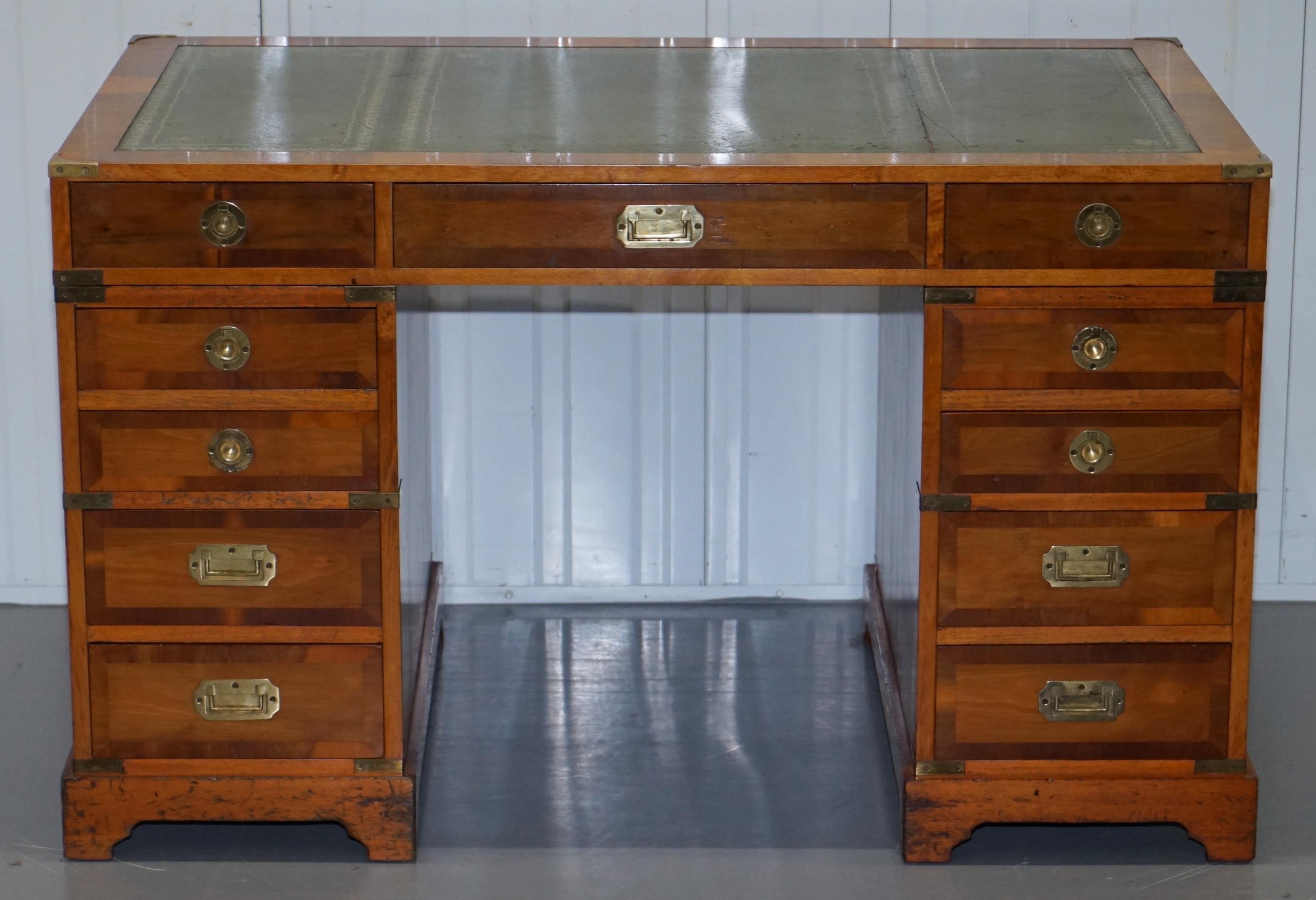 We are delighted to this very well made vintage yew wood military campaign partner desk

A good looking desk, the yew wood is nicely cut and has a nice warm glow to it, the top is green leather with gold leaf embossing. The handles are all brass