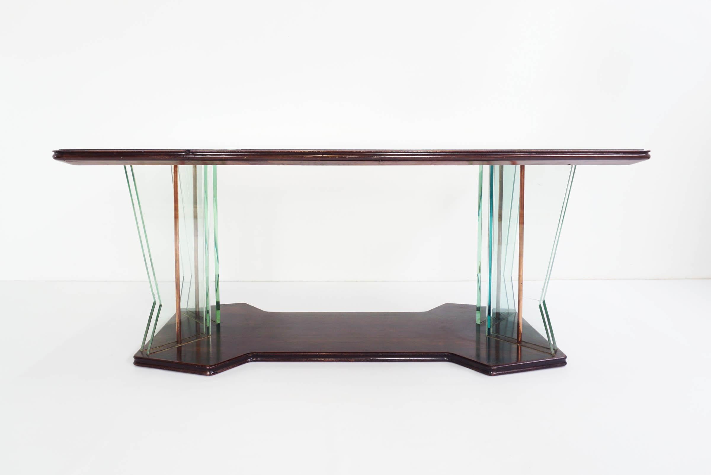 Legs in massive glass with support in copper 
Top cover with black reverse-painted glass.