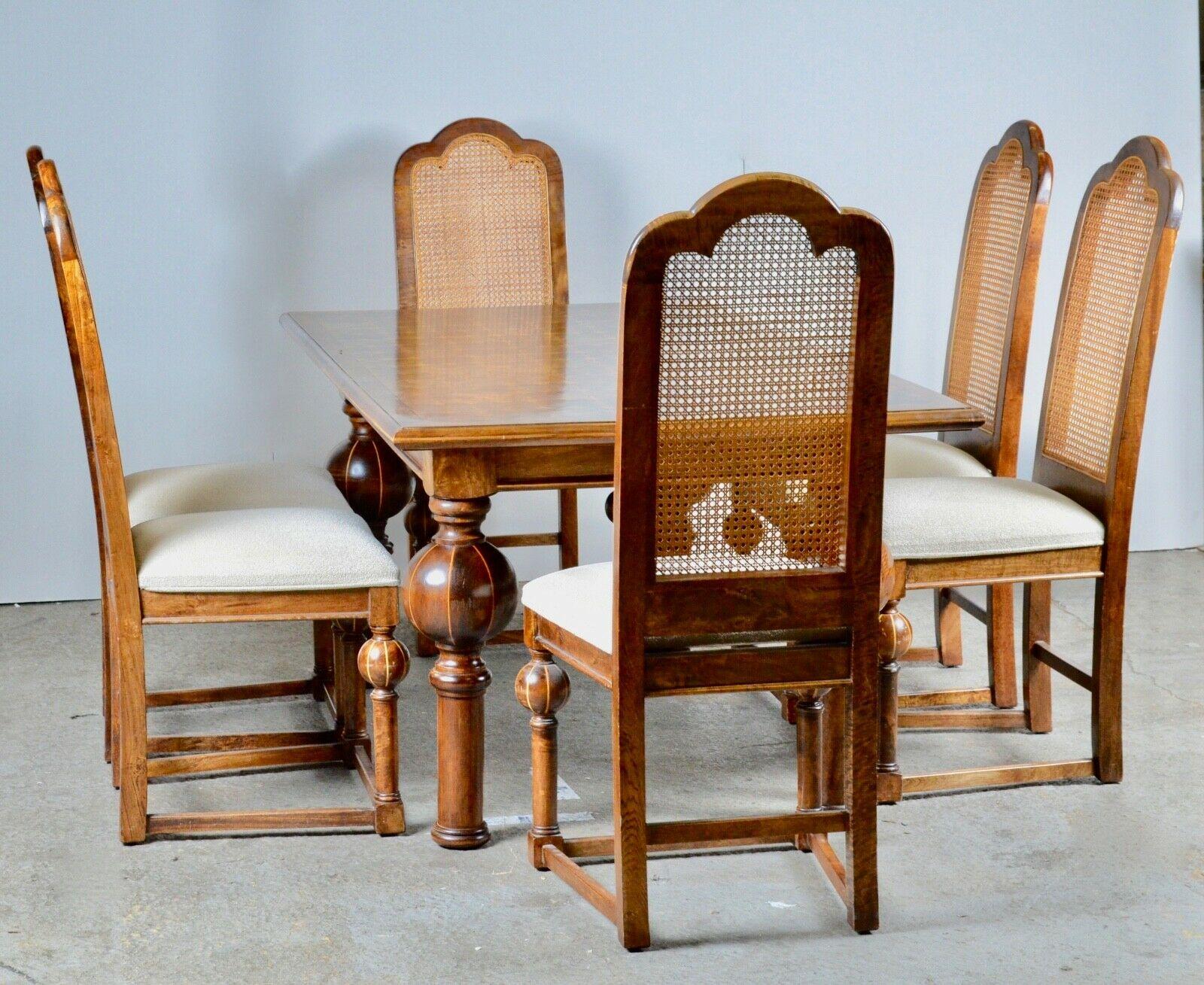We are delighted to offer for sale this quality country farmhouse dining table and suite of six chairs. The table is made of solid hardwood with walnut parquetry inlay and the chairs with cane backs. The condition is as good as it looks, we have