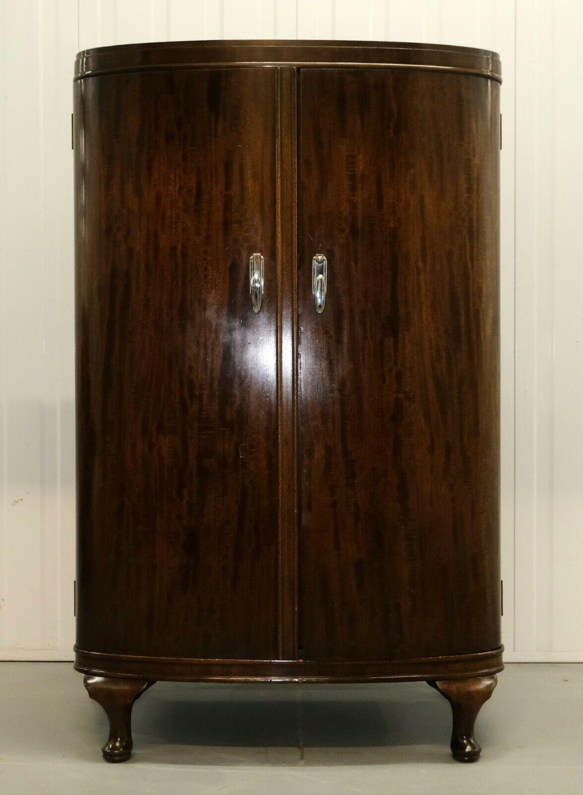 We are delighted to offer for sale this stunning Warring & Gillow Mahogany Ladies Wardrobe with bow front and shelves.

This charming item shows elegance with the bow front doors and four cabriole legs making it unique from other furniture. Its
