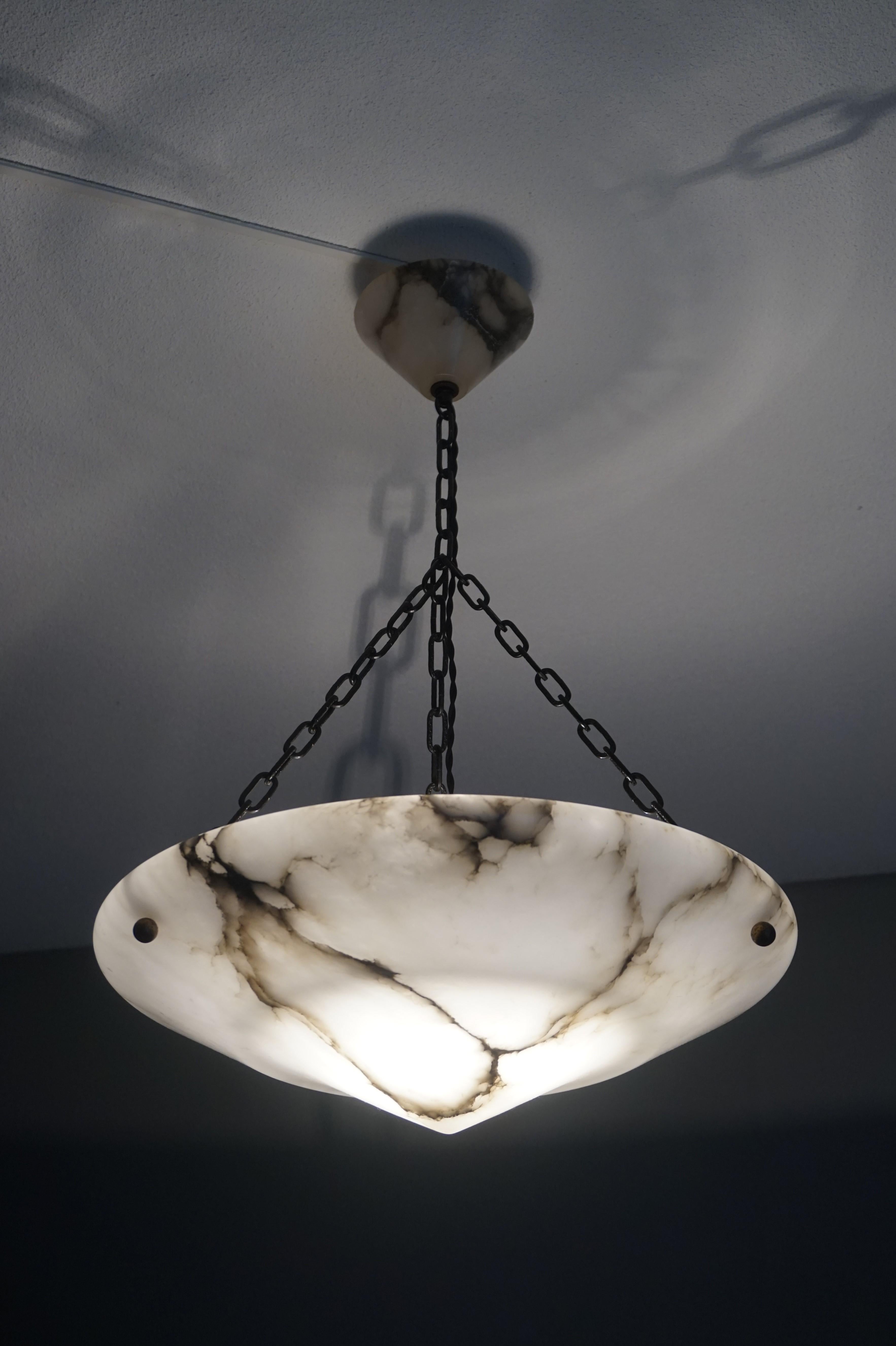 Perfect size, great design and superb condition Art Deco light fixture.

With early 20th century lighting being one of our specialties, we were immediately impressed with the size, shape and excellent condition of this alabaster chandelier. Over the