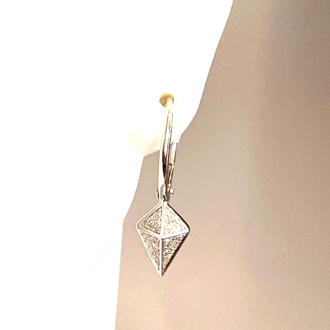 Elevate your style with these Gorgeous White Gold Triangle Diamond Drop Earrings. Each earring features a stunning 0.15-carat triangle-shaped diamond that sparkles beautifully in the light. The earrings weighing 1.90grams are made of 14K white gold,