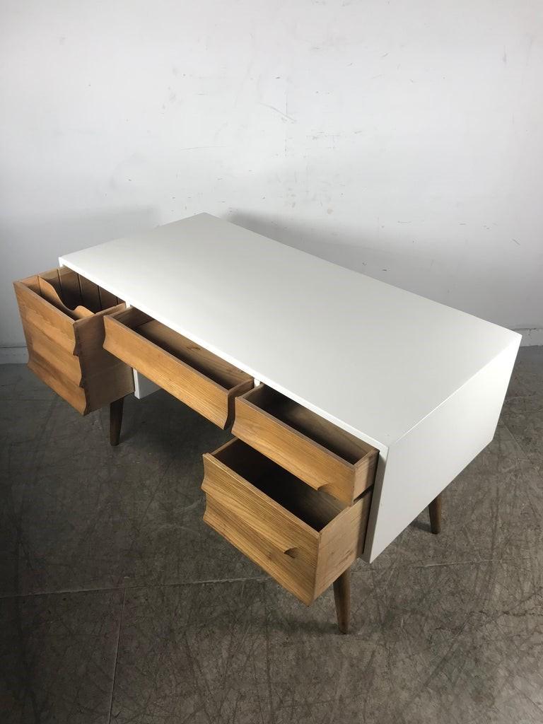 Fully restored white lacquer and oak desk designed by Jack Van der Molen for Jamestown Lounge Company, Jamestown, NY circa 1050's. This desk was part of the successful 
