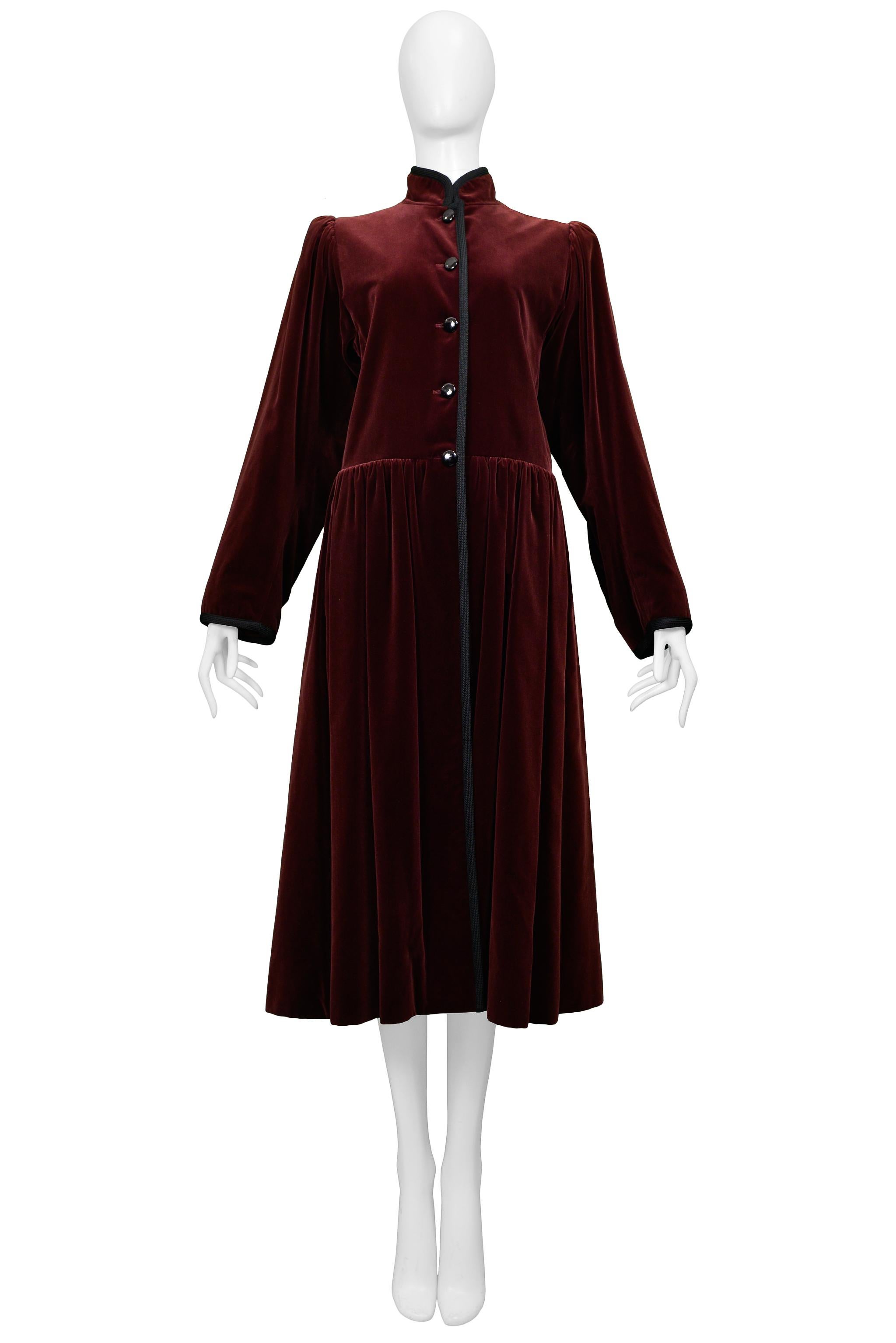 Resurrection Vintage is excited to offer a classic vintage Yves Saint Laurent burgundy velvet coat featuring a high collar, slightly high empire waistline, gathered skirt, contrasting black trim and buttons, and silk lining.

Yves Saint Laurent
Size