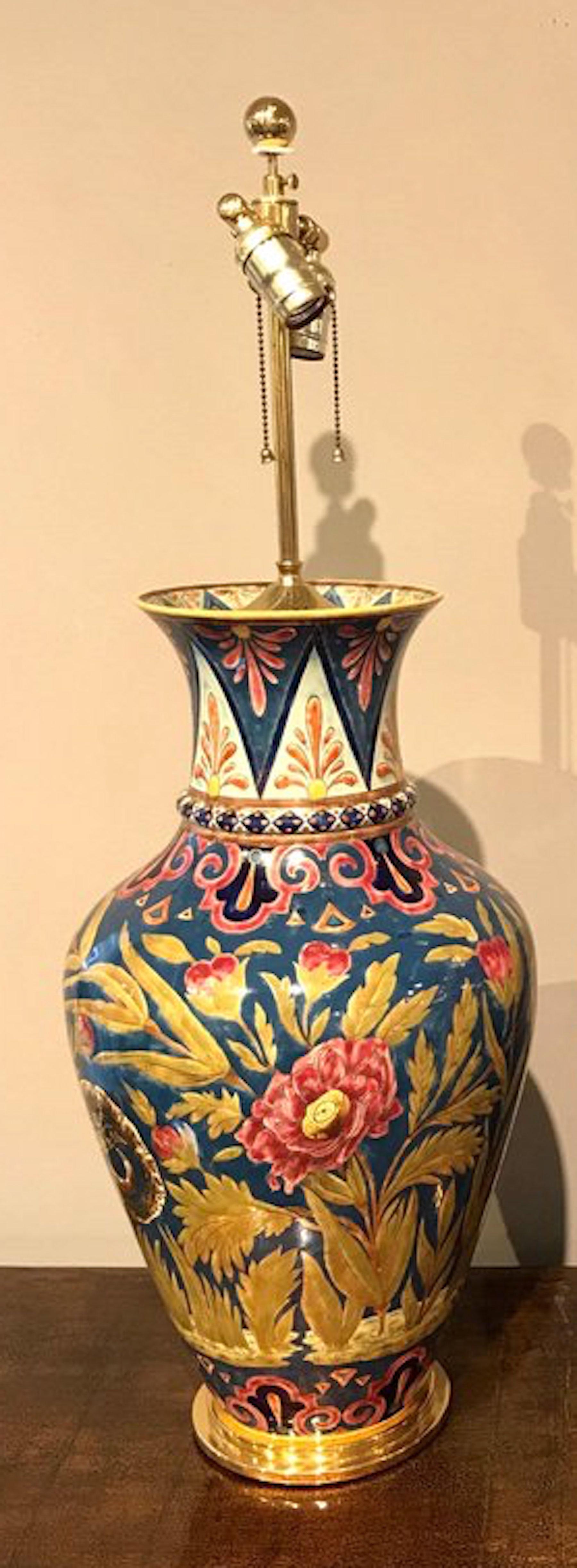 A large stunning attributed to Zsolnay porcelain floral vases now as lamps. All-over typical enameled and painted floral decoration, with brass mounts. Professionally drilled for electrification, no chips cracks or repairs. New wiring. Measures: