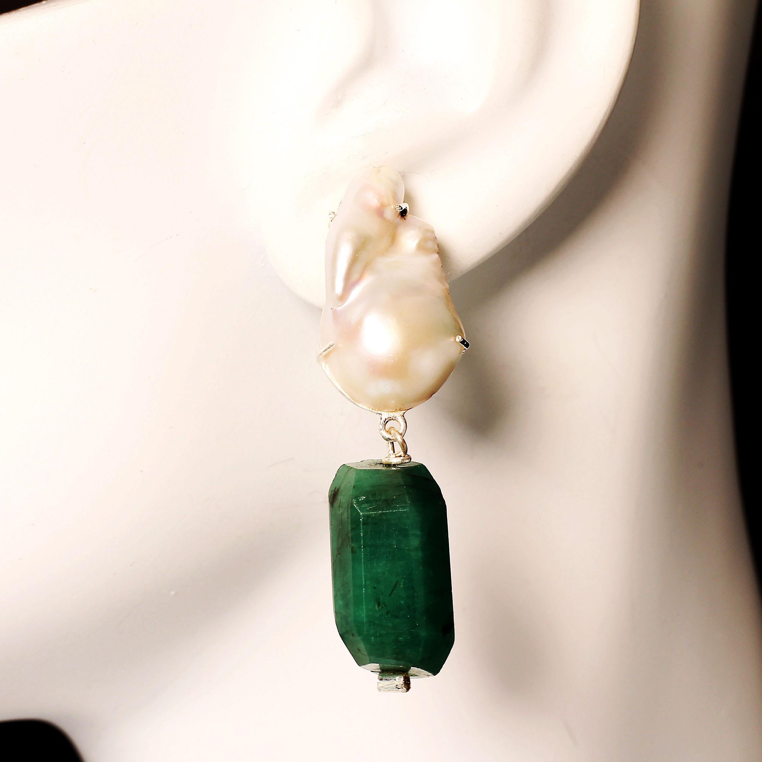 Elegant earrings of iridescent white Baroque Pearl with a polished Emerald nugget drop. These impressive Gemjunky earrings are a delight to wear. The gems are set in Sterling Silver settings with post and omega back. The Emerald nugget is attched