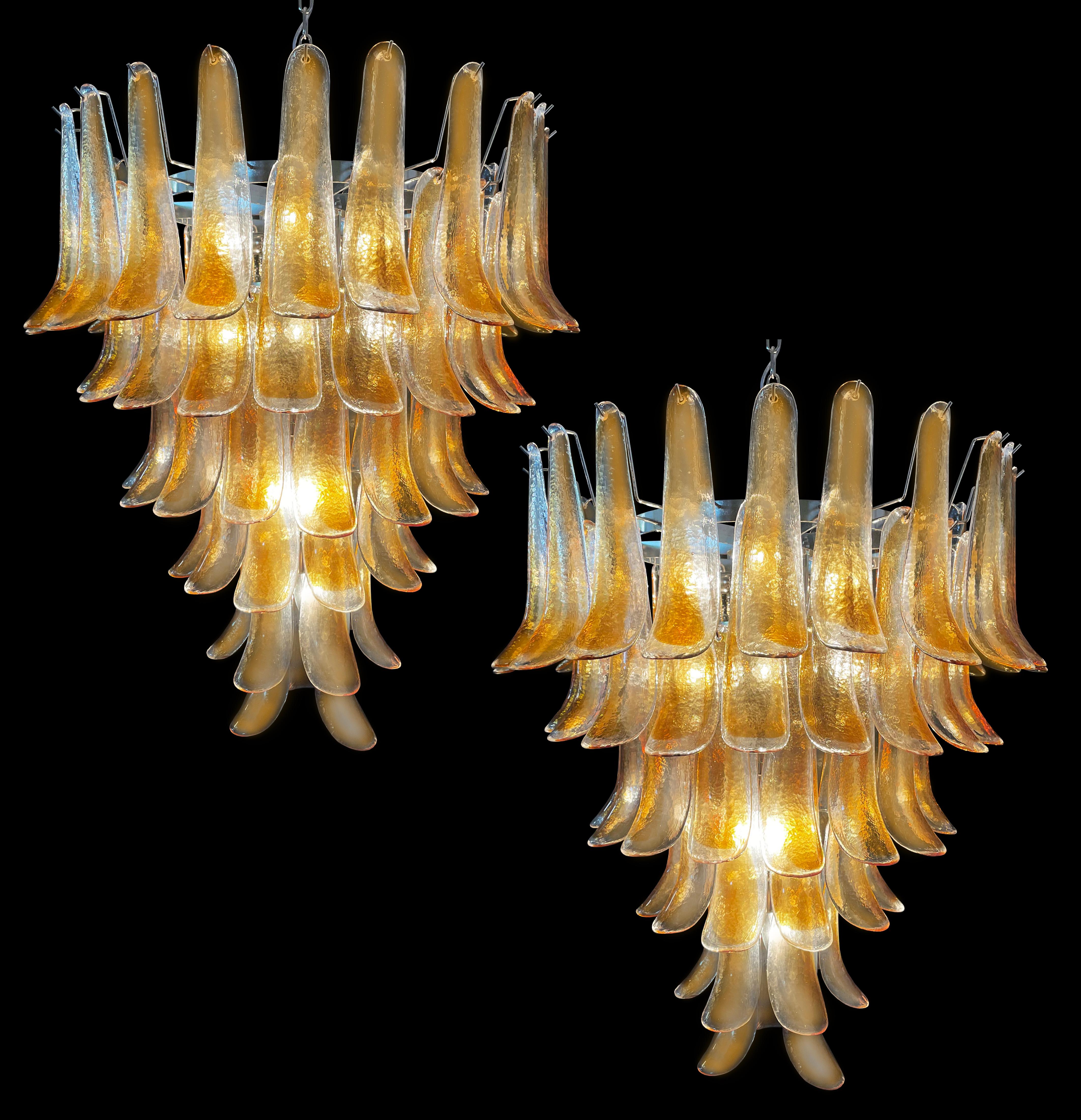Pair Italian vintage Murano chandeliers. Each made by 75 glass petals transparent with an amber spot inside, nickel metal structure. The glasses are very high quality, the photos do not do the beauty, luster of these glasses.
Period:late XX