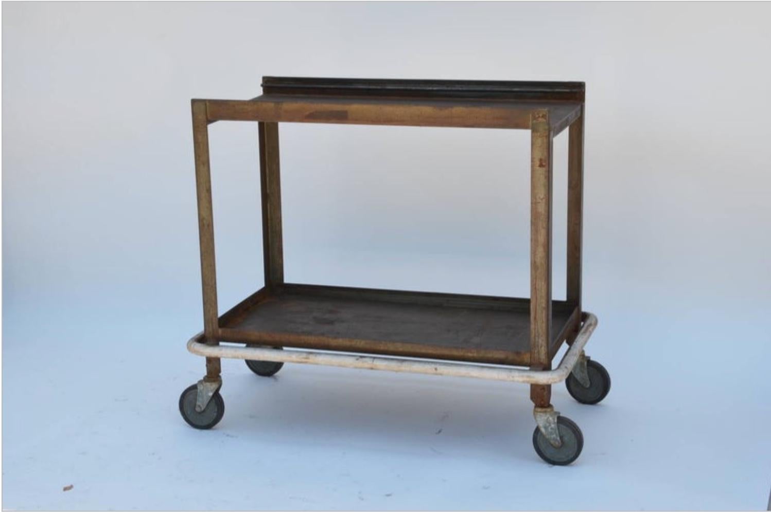 Sturdy industrial bar cart on wheels. Also great as an industrial console in the kitchen or anywhere else in the house.
