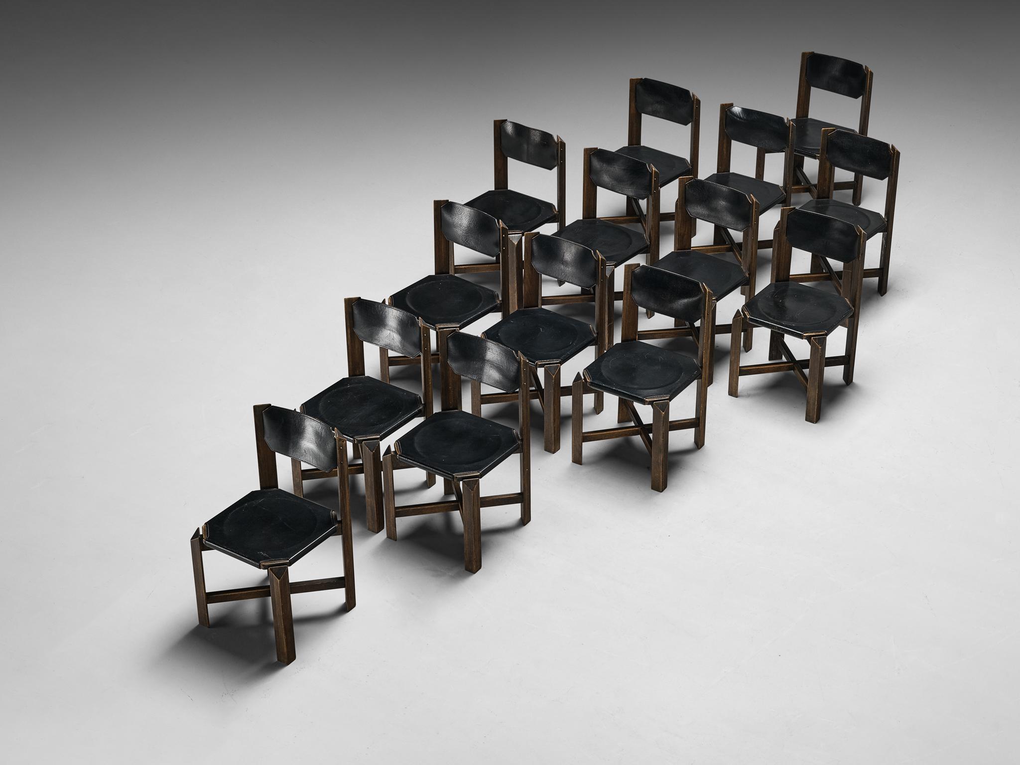 Set of fourteen dining chairs, leather, beech, Europe, 1970s

These dining chairs embrace a sturdy construction, featuring durable black leather upholstery complemented by a robust wooden framework. The architectural design showcases precise
