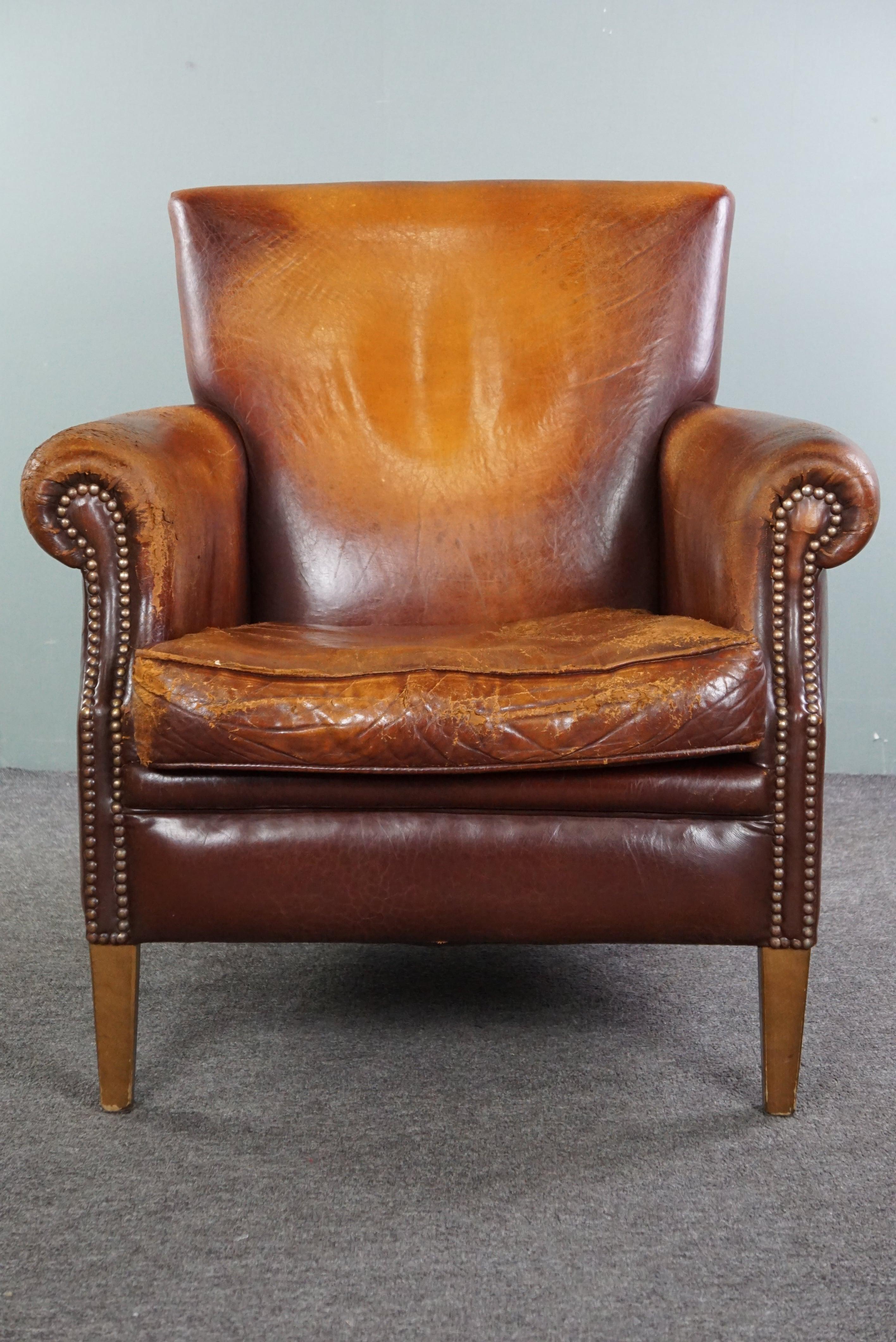 Offered is this armchair made of sheep leather, featuring plenty of patina and character. Isn't this just awesome, don't you think? A positively weathered sheep leather armchair with a delightful worn look is precisely what would add so much more