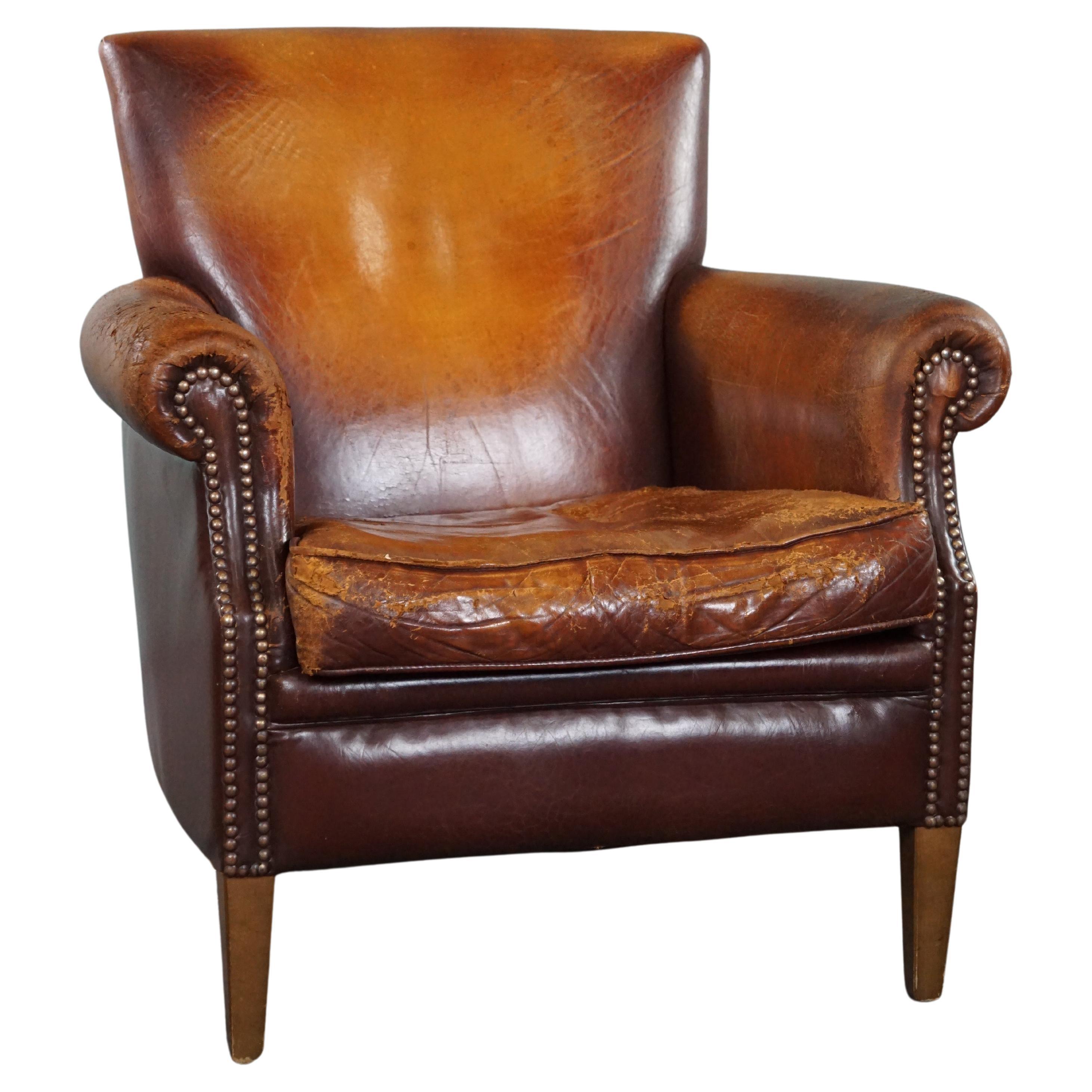 Sturdy sheep leather armchair with a distressed look For Sale
