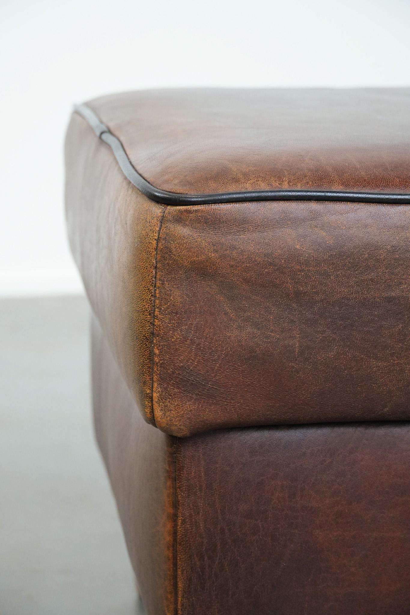 Robusto pouf in pelle di pecora d'epoca di grandi dimensioni con profili neri in vendita 1