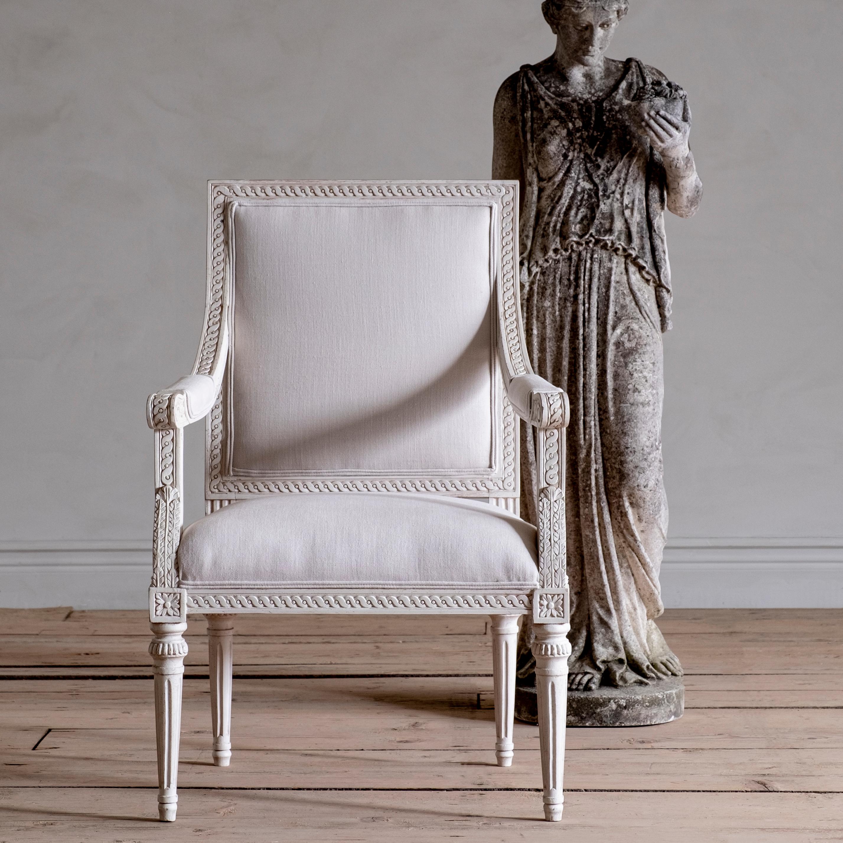 This fine Gustavian style armchair is inspired by a remarkable Gustavian period square back armchair from our own collection. With fine carvings thru out the entire chair. Originally designed and made by Stockholm chair master Melchior Lundberg