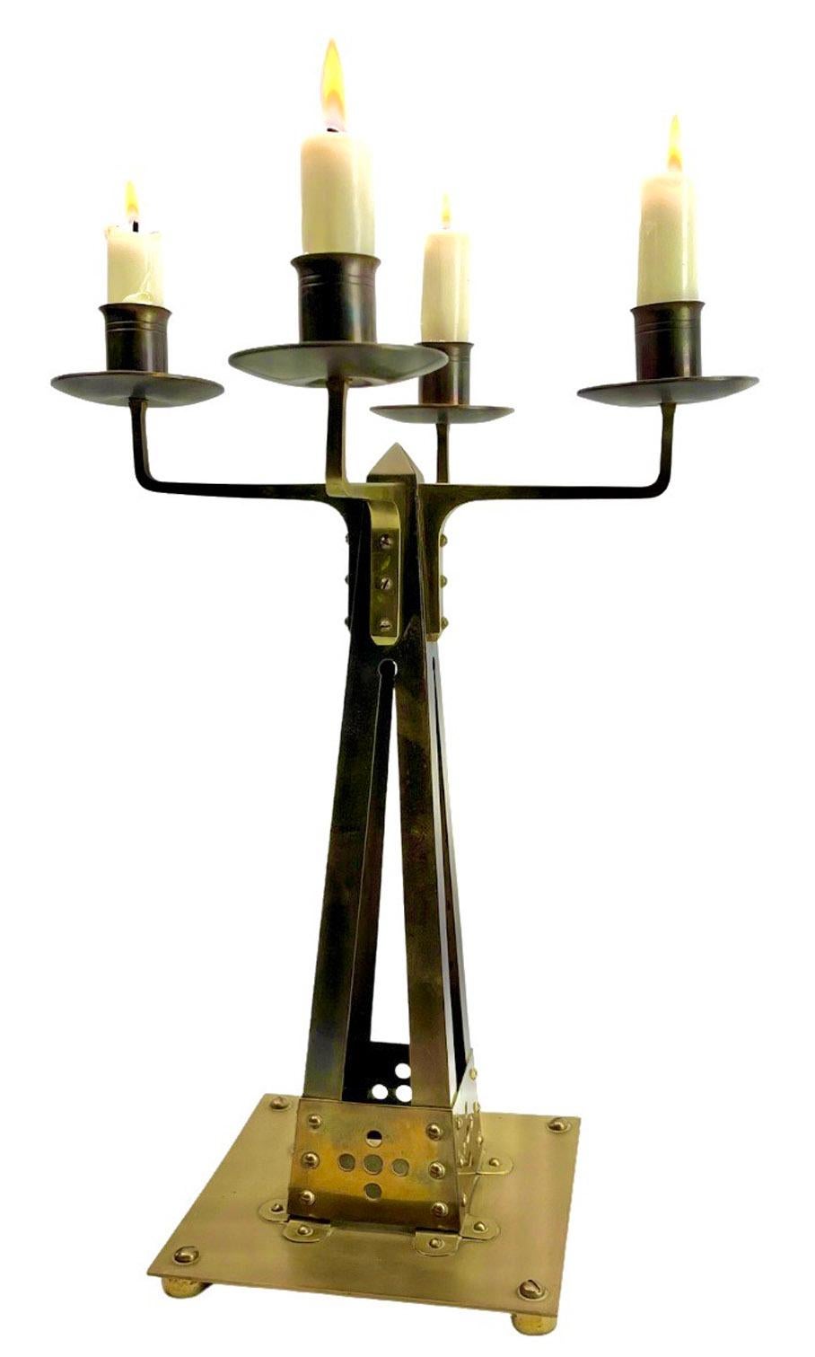 J.K.C Sneltjes Haarlem Dutch Large Arts & Crafts Copper and Brass Candleholder

Yellow copper four-light candlestick, made by Sneltjes in Haarlem in ca. 1910

The base, and the upright candle holder is in brass. The square base has a pierced design