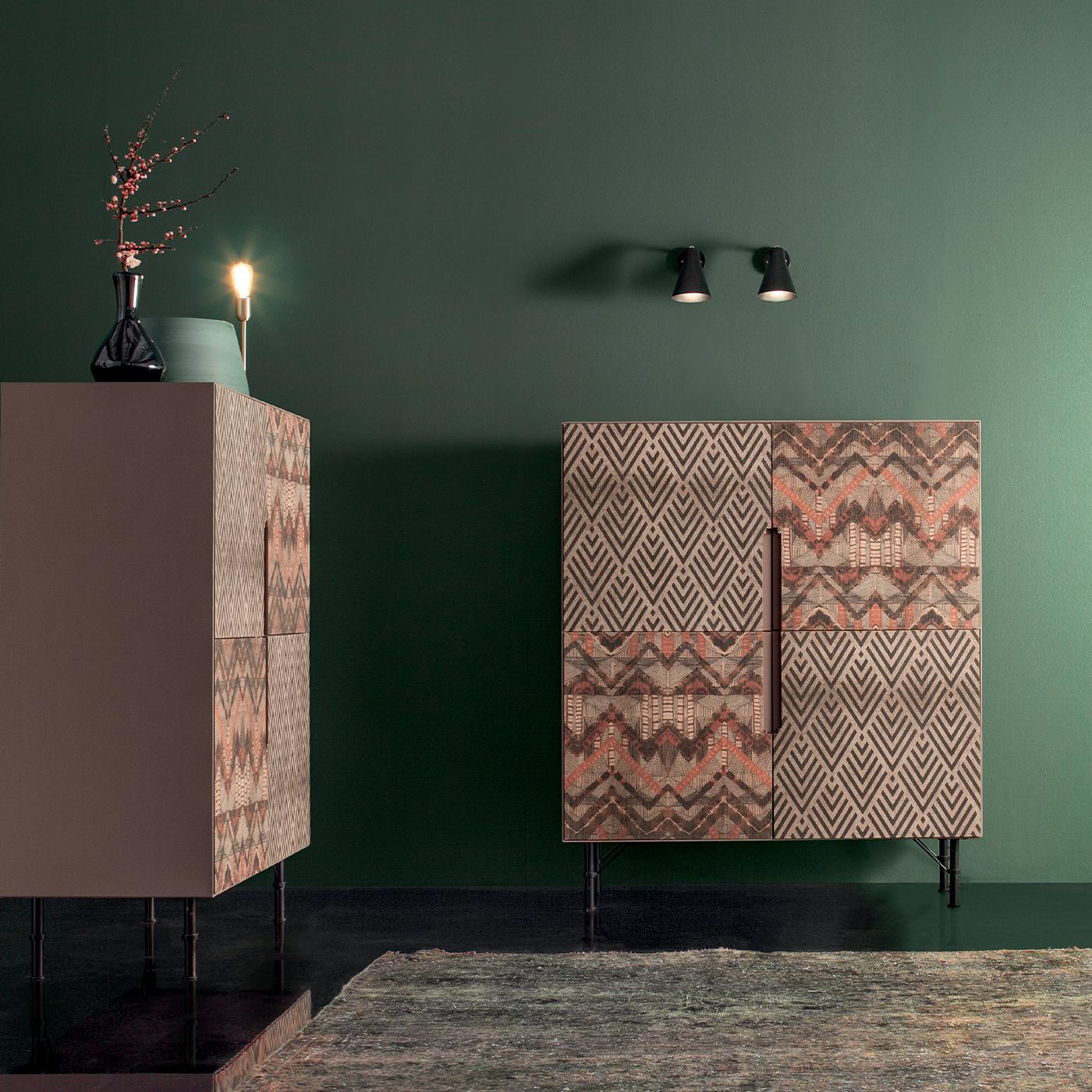 This stylish storage unit makes a practical yet stylish addition to the home. Its four doors are embellished with two contrasting geometric motifs, showcasing a combination of muted tones that blend seamlessly with a range of interior styles. The