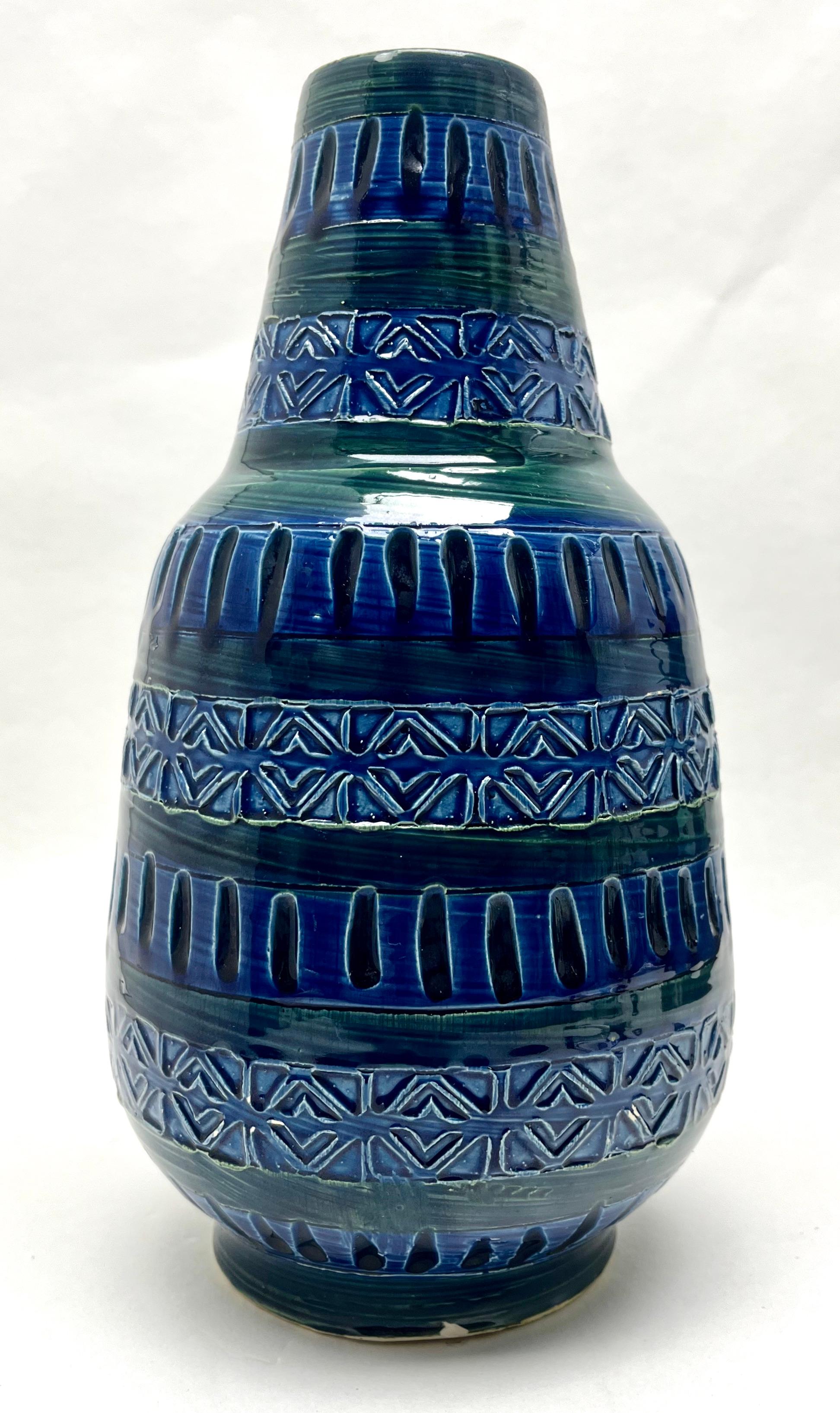 

Vintage vase in blue or black drip glaze featuring the indented
On close inspection the glaze includes flecks black and sea-blue which give greater depth to the surfaces.

Please don't hesitate to get in touch with any further