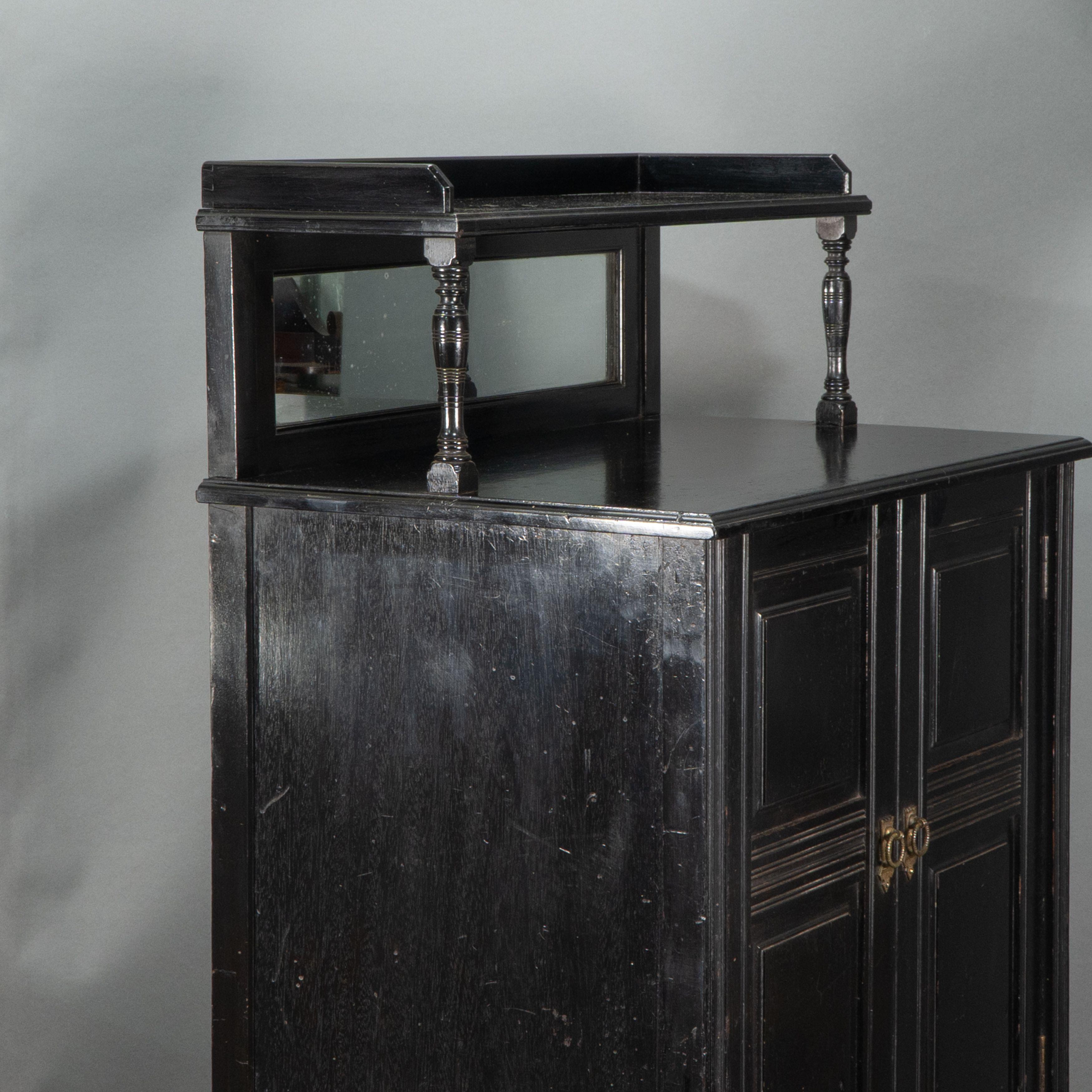 Walnut Style of E W Godwin. An Aesthetic Movement ebonized cabinet For Sale