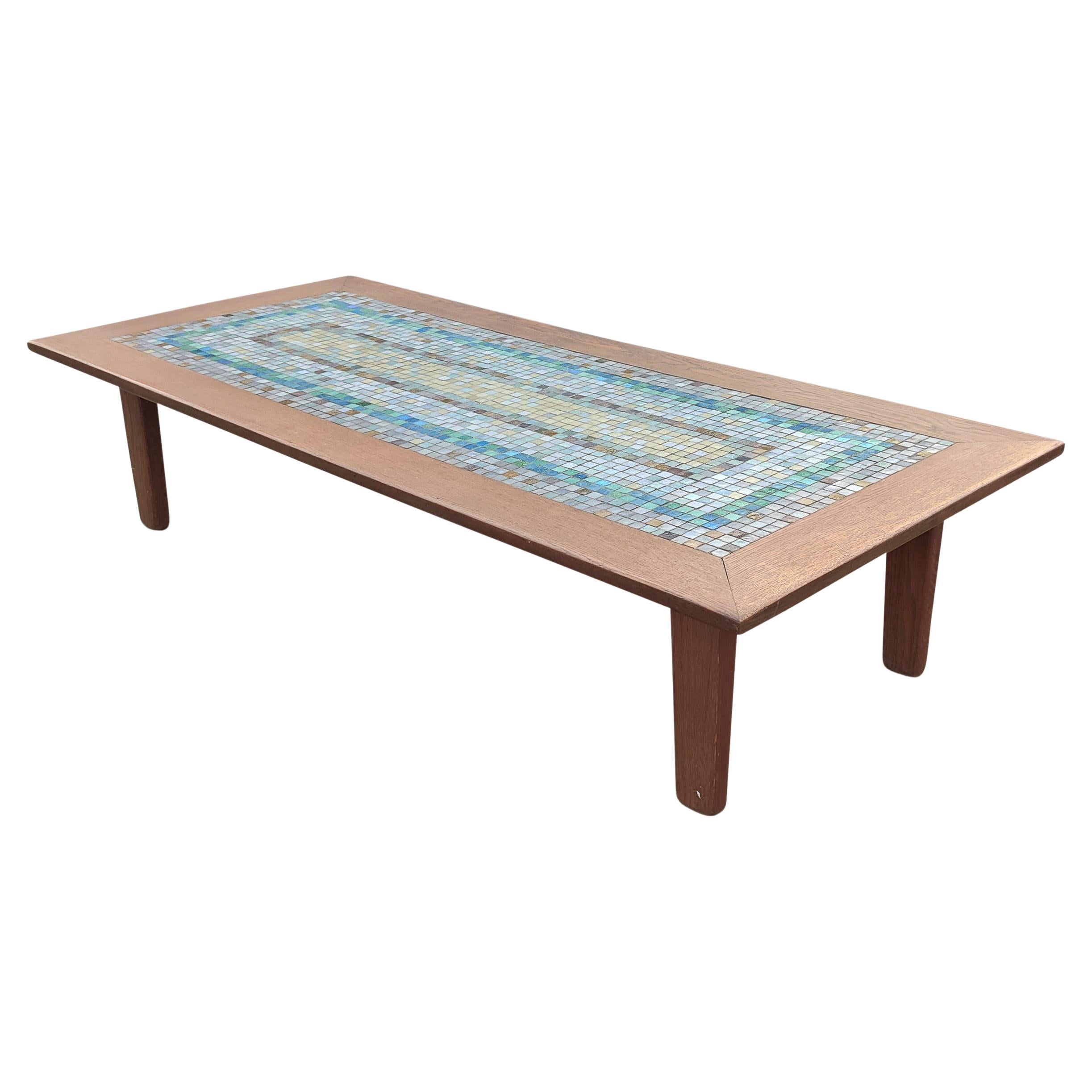 This coffee table was designed and hand-built by Kurt G Kurtis, a listed painter and craftsman, and is very large, and super good looking! At over 70 inches long, its heft not only lies in its size but also its materials. It's made of solid oak