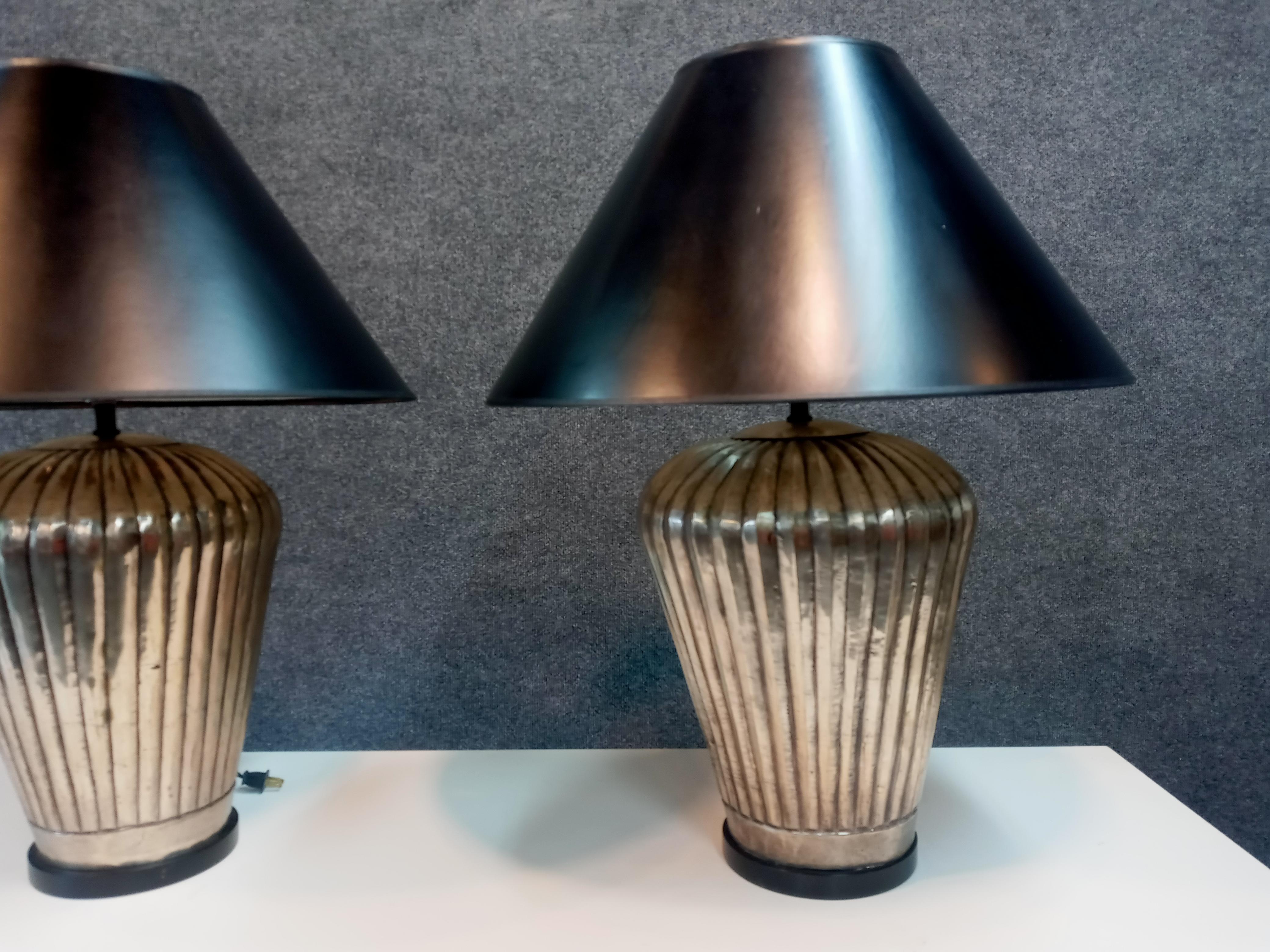 Pair of vintage hammered metal table lamps with original hardware and shades. 

With shades: 26 x 20 diameter

Without shades: 14.5 x 10 diameter

Lamps are single socket and in good working order.