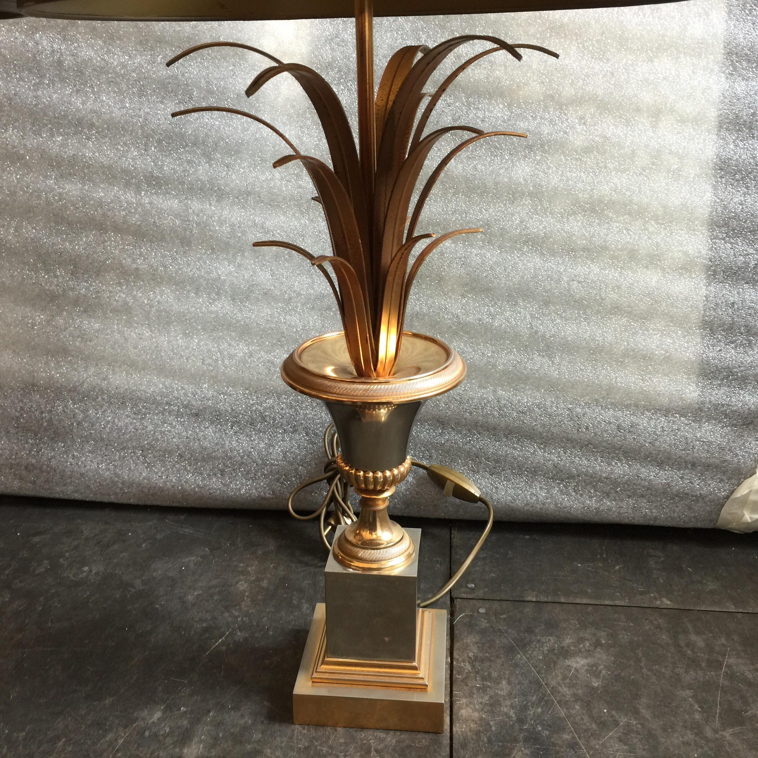 This lovely pair of brass and brushed steel table lamps boast the original matching shades (included). The wheat reeds atop an urn in mixed metals - 3 bulbs/sockets. Still wired with European sockets (can be rewired at a small additional cost).