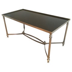 Table basse argentée dans le style de la Maison Jansen, avec verre laqué noir