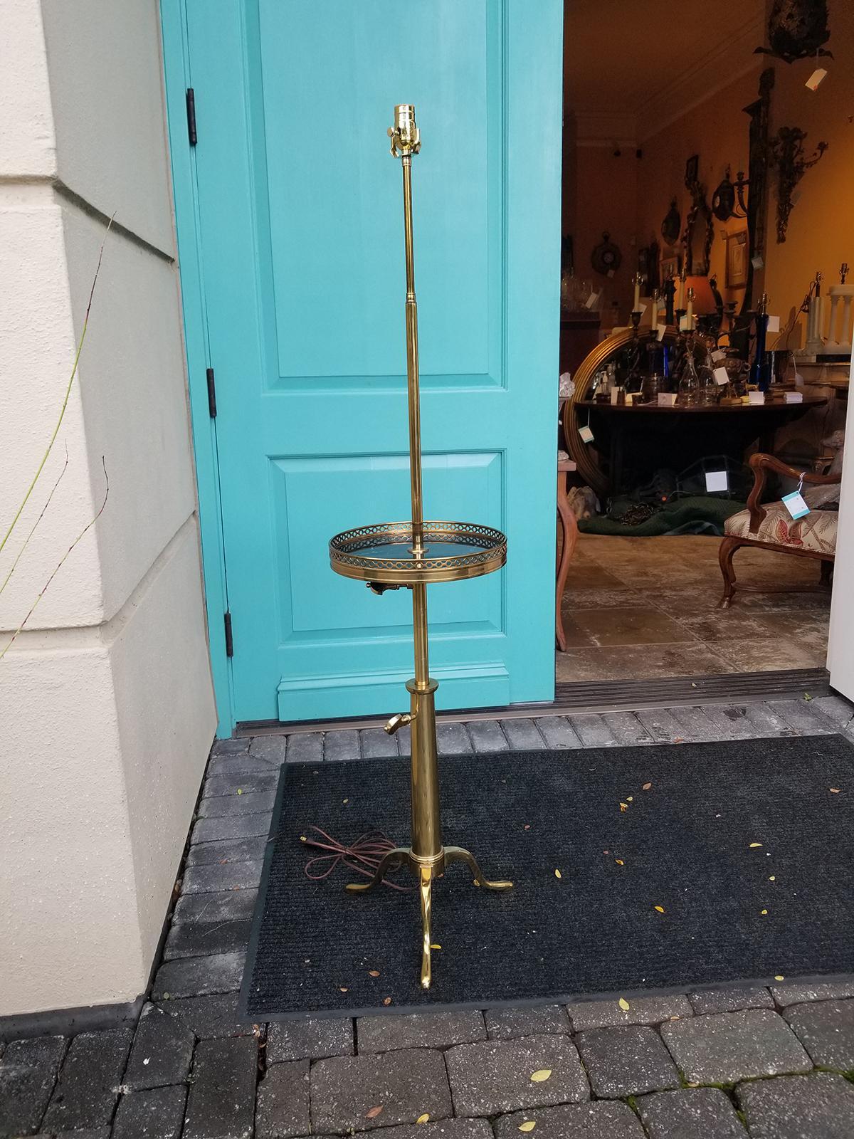 Style of Maison Toulouse Brass floor lamp with marble top table, brass gallery.