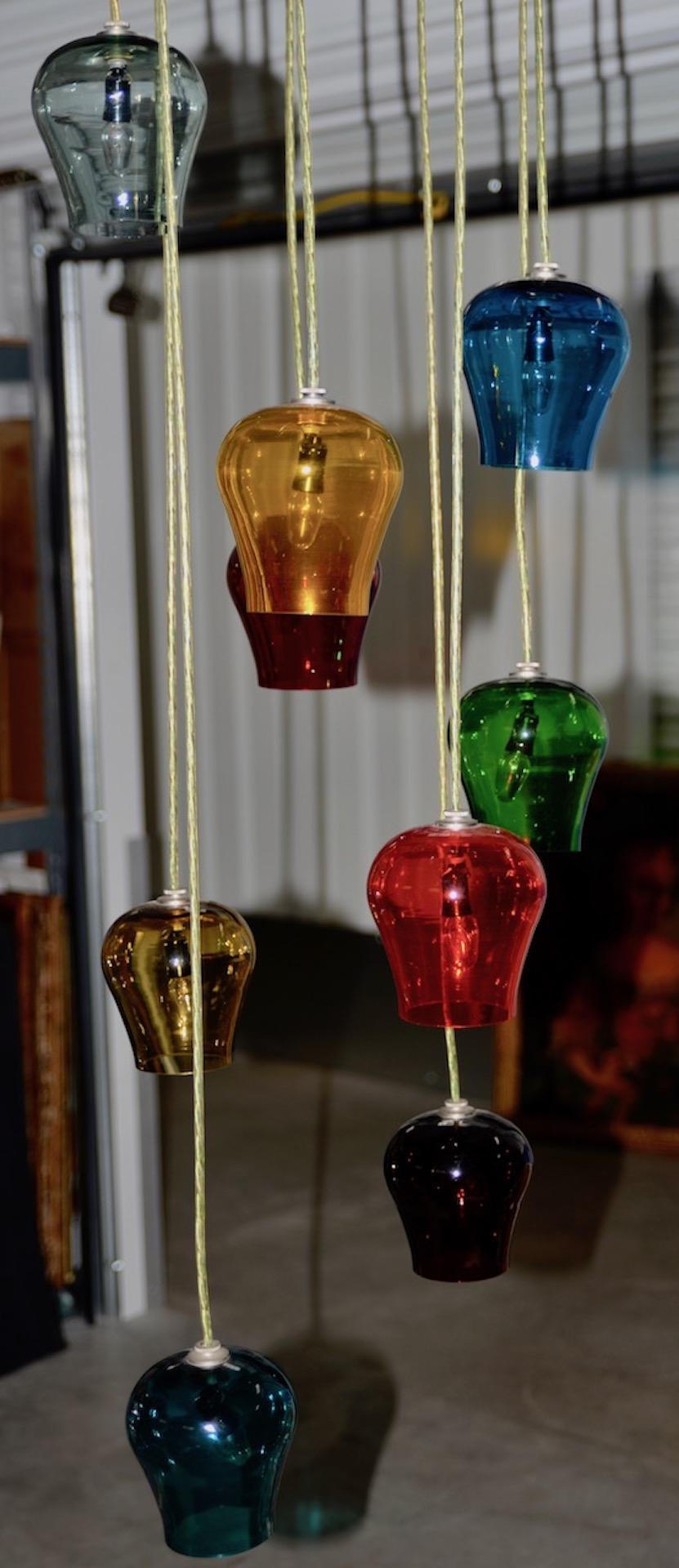 Style of Morris Lapidus hand blown multicolored glass goblets chandelier, circa 1960s

Fantastic hanging pedant chandelier with 9 lights. The height for each light can be easily adjusted.

Each goblet measures 4.5