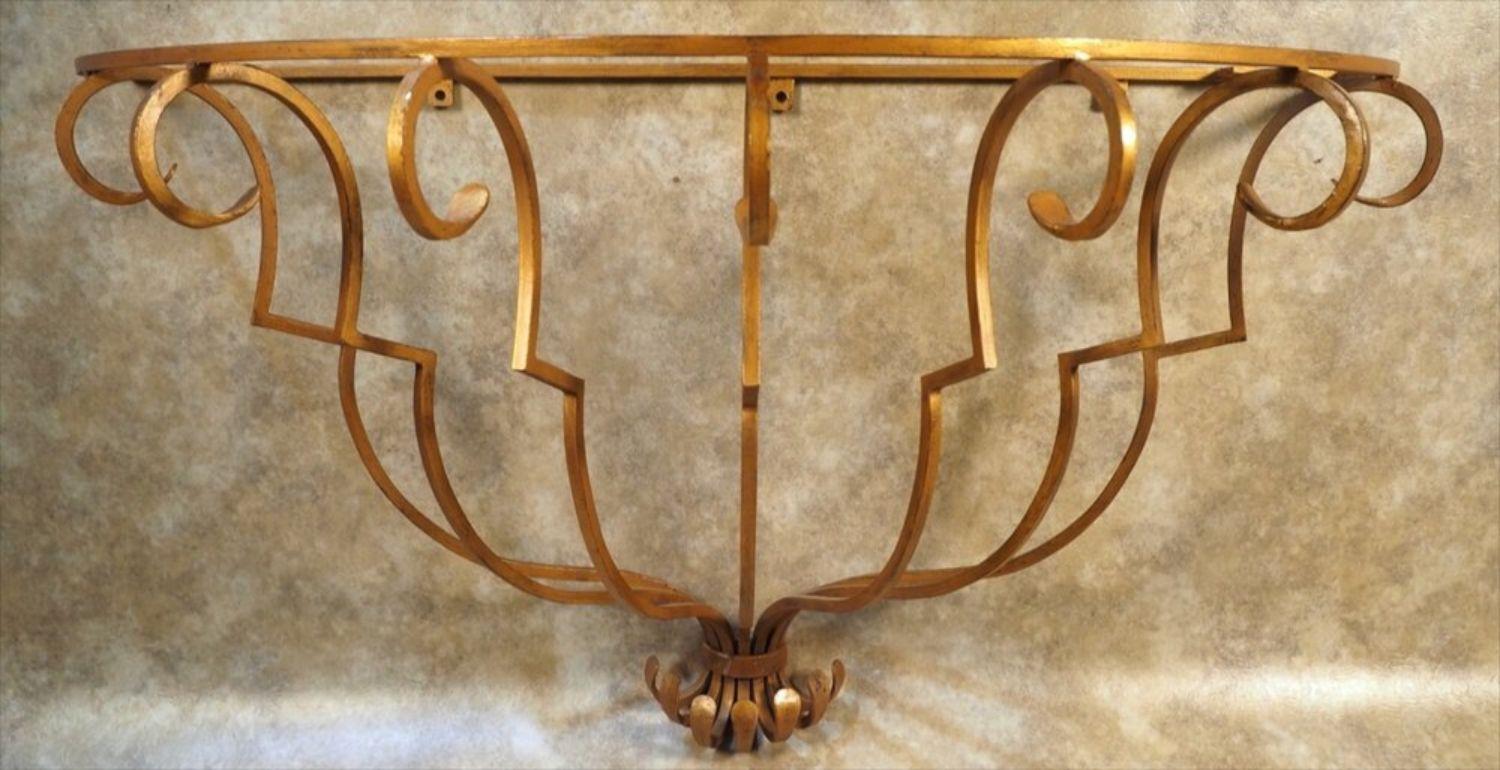French 1940s Art Deco gilt forged iron wall mount console in the style of Raymond Subes. Measures: 48