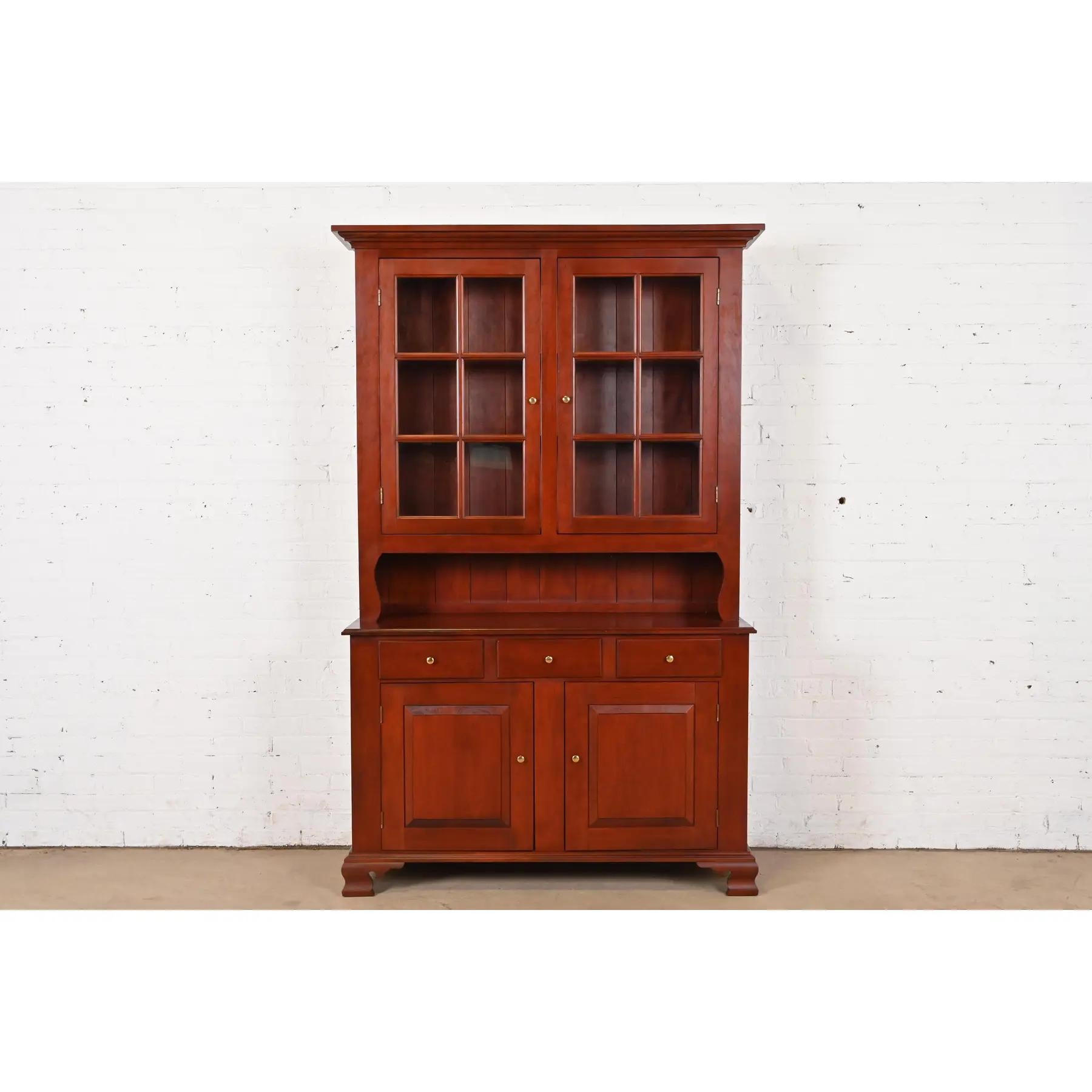 A gorgeous Shaker or American Colonial style lighted breakfront bookcase cabinet or sideboard buffet with hutch top

By Tom Seely Furniture

USA, Late 20th Century

Gorgeous solid cherry wood, with mullioned glass front doors, and original brass