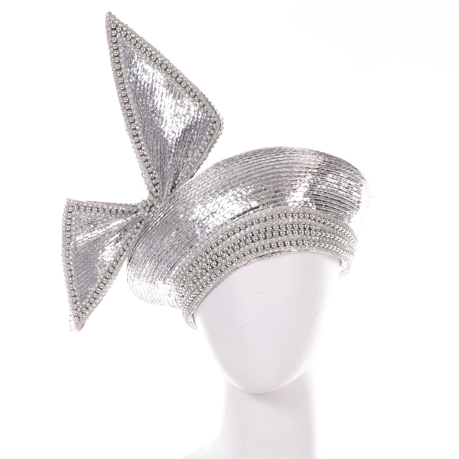 This is the perfect statement had from the 1960's designed by Jack McConnell. We love the small silver beads and crystal embellishments. This hat is a turban style with a big asymmetrical structured bow. The hat has the coveted Styled by Jack