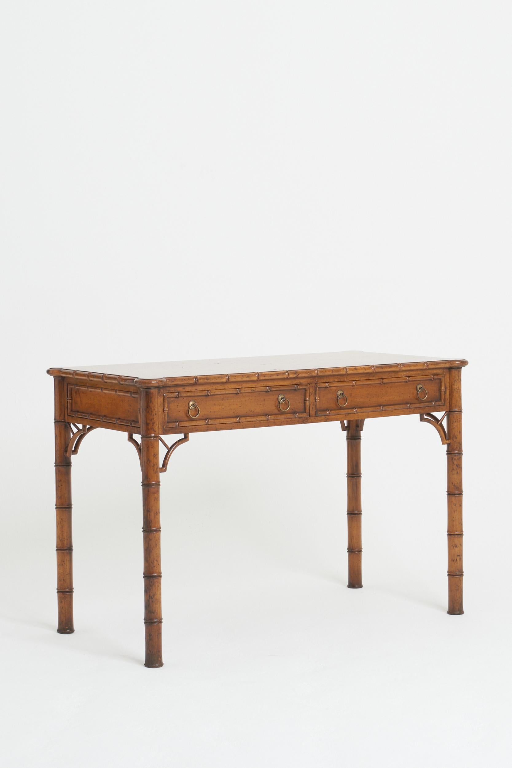 A stylised faux painted stylised bamboo desk. 
Spain, Mid 20th Century
76 cm high by 110.5 cm wide by 57.5 cm depth