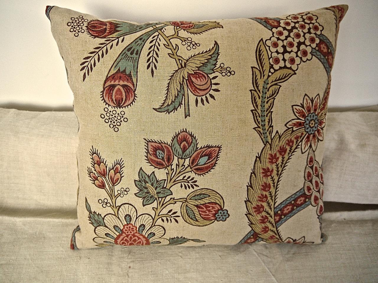 French later 19th century linen cushion with a large scale design of stylised flowers and a patterned and twisting column. The flowers and buds printed in shades of soft raspberry red and a pale blue. Self-backed and slipstitched closed with a duck