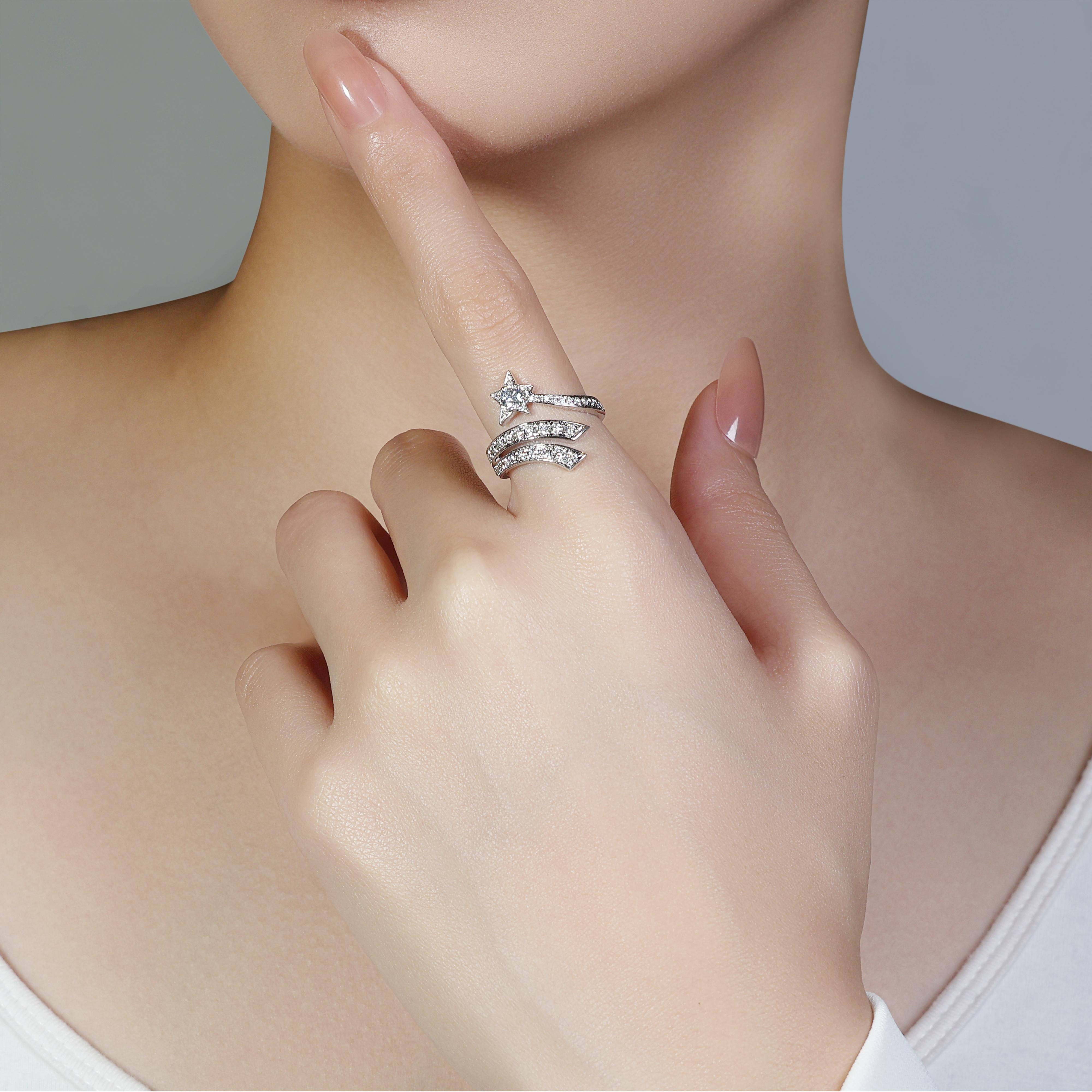 This stunning ring features a brilliant-cut center diamond weighing 0.19 carats, graded G for color and VS for clarity. The center stone is surrounded by a halo of 40 smaller diamonds, each weighing 0.016 carats, also graded G and VS. The ring is