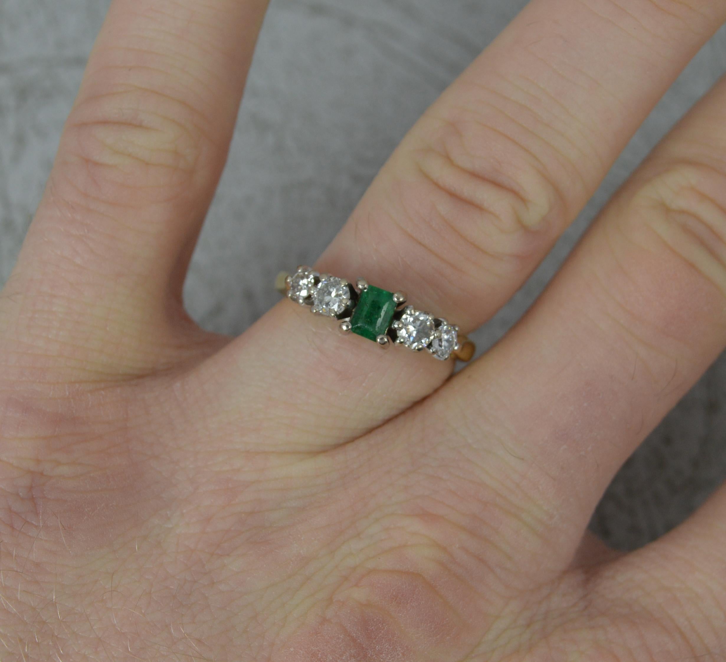 A superb Emerald and Diamond ring.
Solid 18 carat yellow gold example with platinum head setting.
Designed with a natural emerald cut emerald to the centre, 3.4mm x 4.6mm and two round brilliant cut diamonds to each side. Total diamond weight of