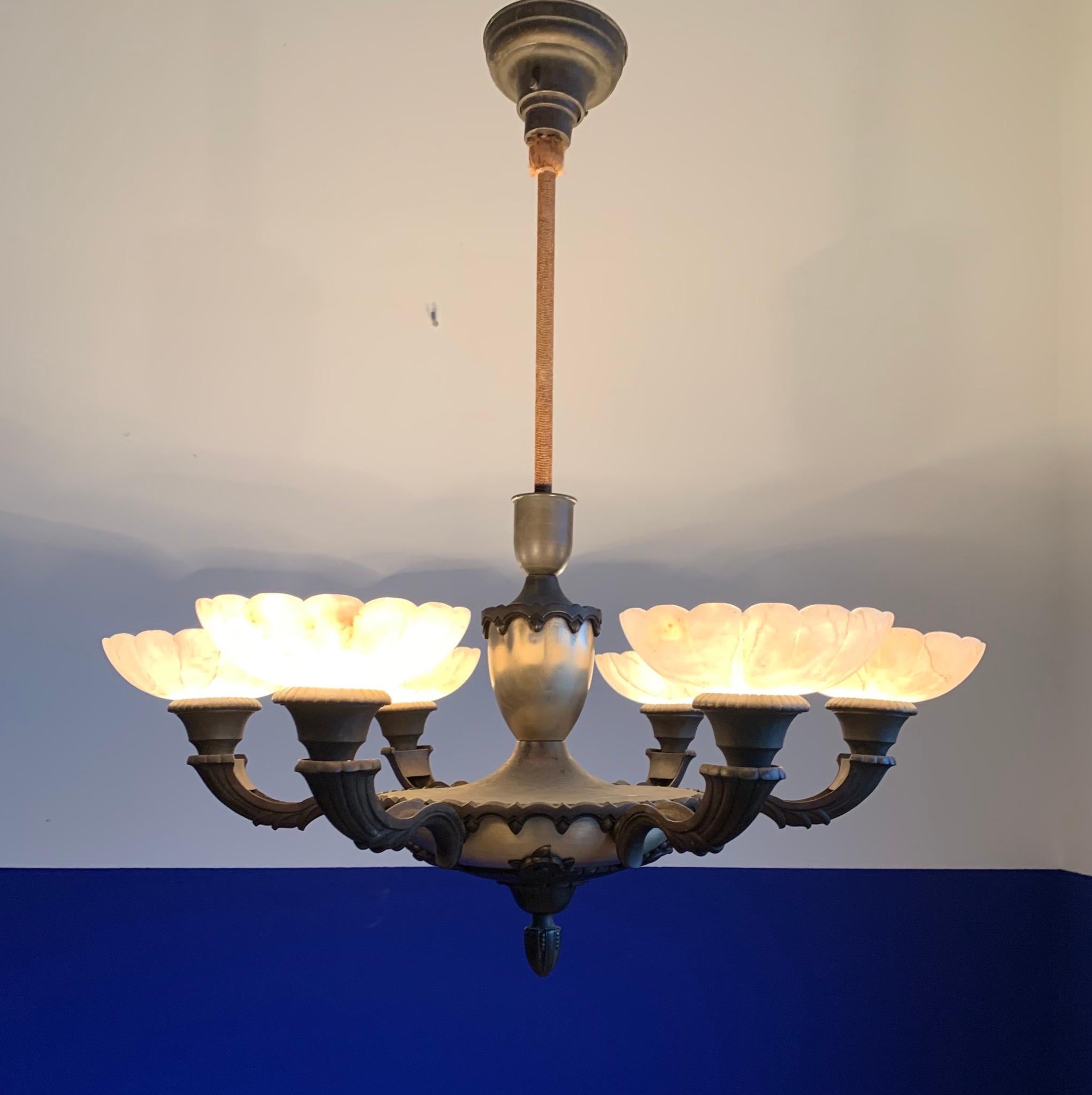 Stunning Art Deco pendant for a great atmosphere.

If you are looking for the perfect chandelier to grace your dining area then this truly stylish Art Deco light fixture could be yours to own and enjoy soon. The combination of the ancient patina of