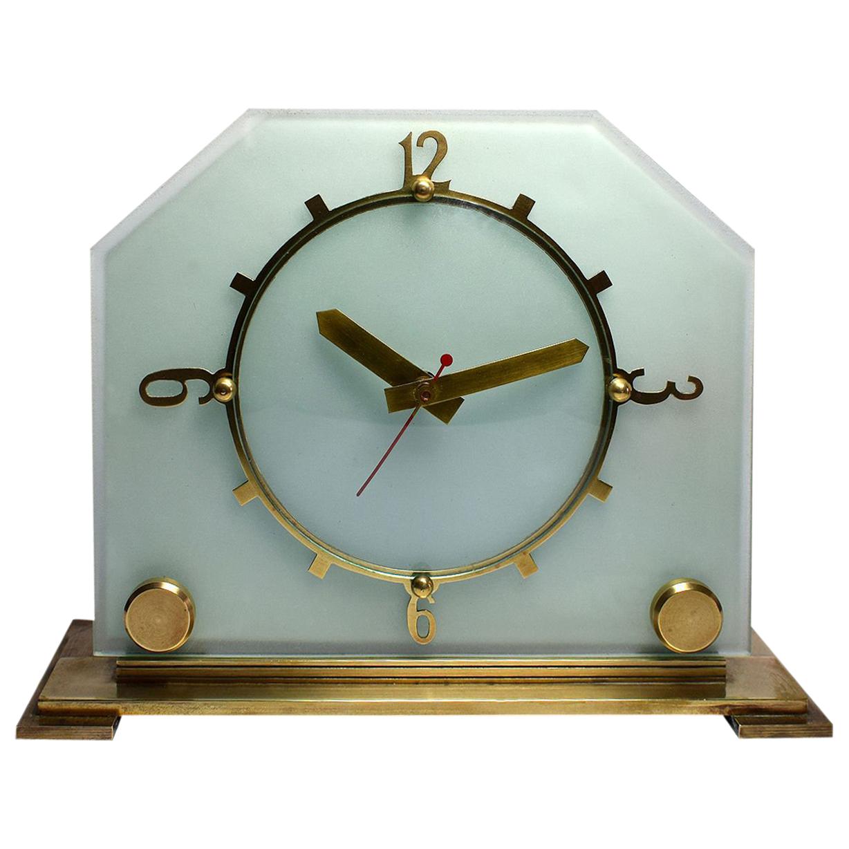 Art Deco at it's finest. Thick glass panel provides the back drop to the dial face, the dial hands, numerals and plinth are all solid brass. All totally original. Condition is excellent there are no flaws to mention. All the brass work is original,