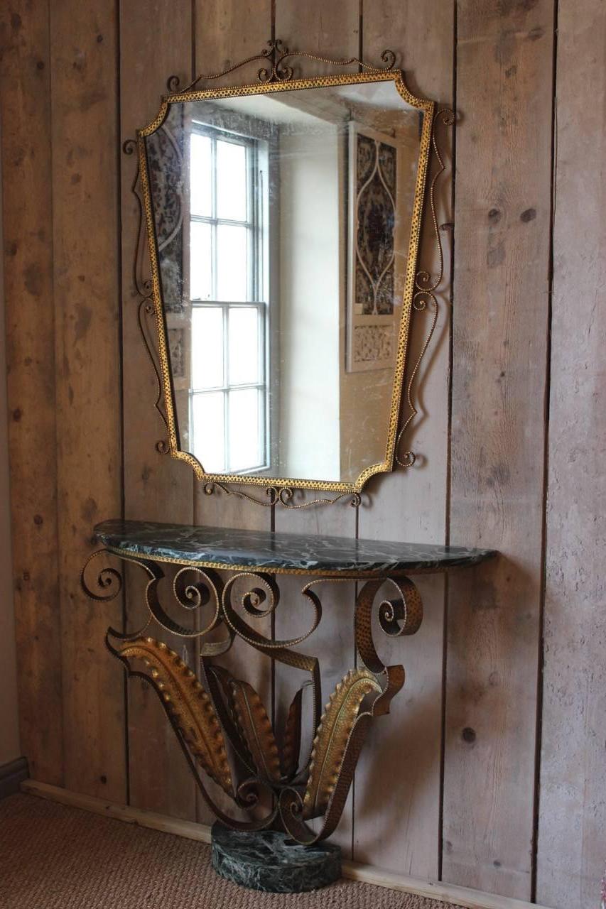 A very stylish 1940s French console table and mirror, of excellent proportions, in gilded iron, with the original marble base and top, together with its original mirror. 

Measurements; the table: 84cm high x 105cm wide x 30cm deep; the mirror:
