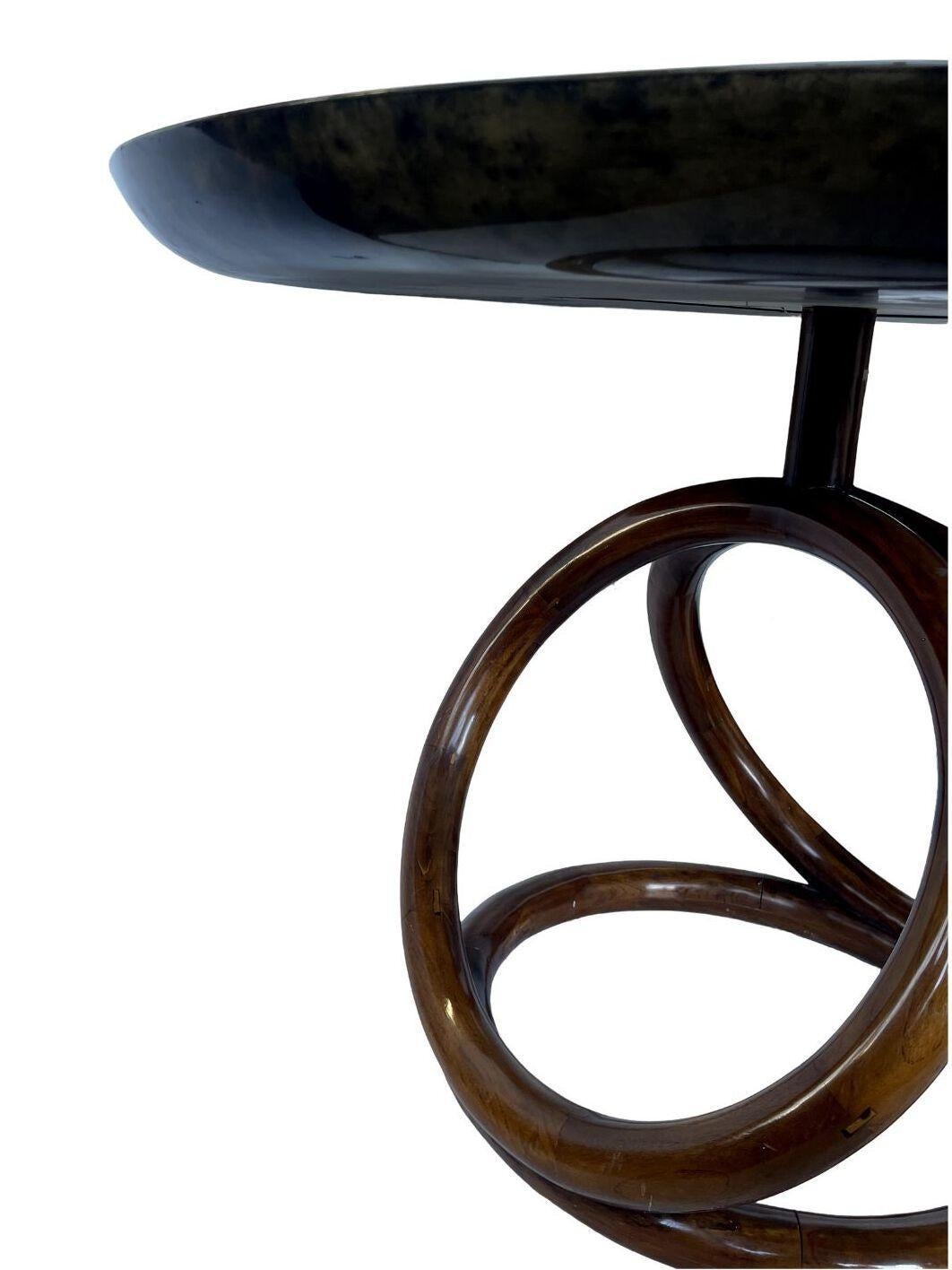 Transform your living space with this exceptional center table, featuring a unique parchment top set atop a striking sculptural teak base. Crafted in Italy in the 1970s, this piece beautifully combines natural materials and artistic design, making