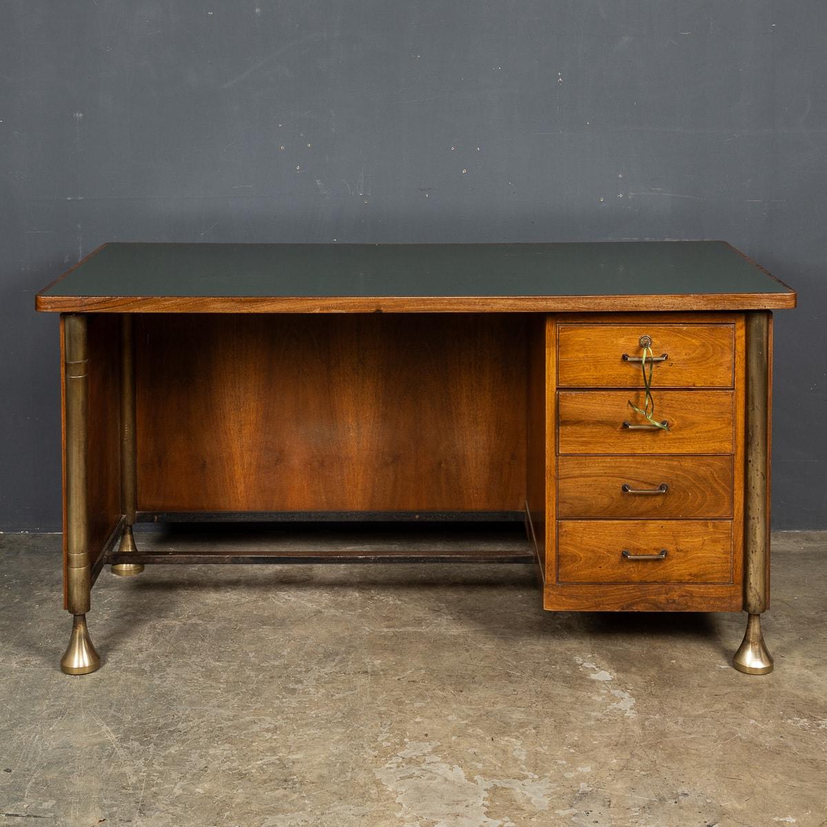 A rare and unusual early 20th Century Italian art deco desk, finished in a light mahogany with simple solid brass legs, brass handles on the four drawers and comes included with the original lock and key for the top drawer. The desk top comes in the