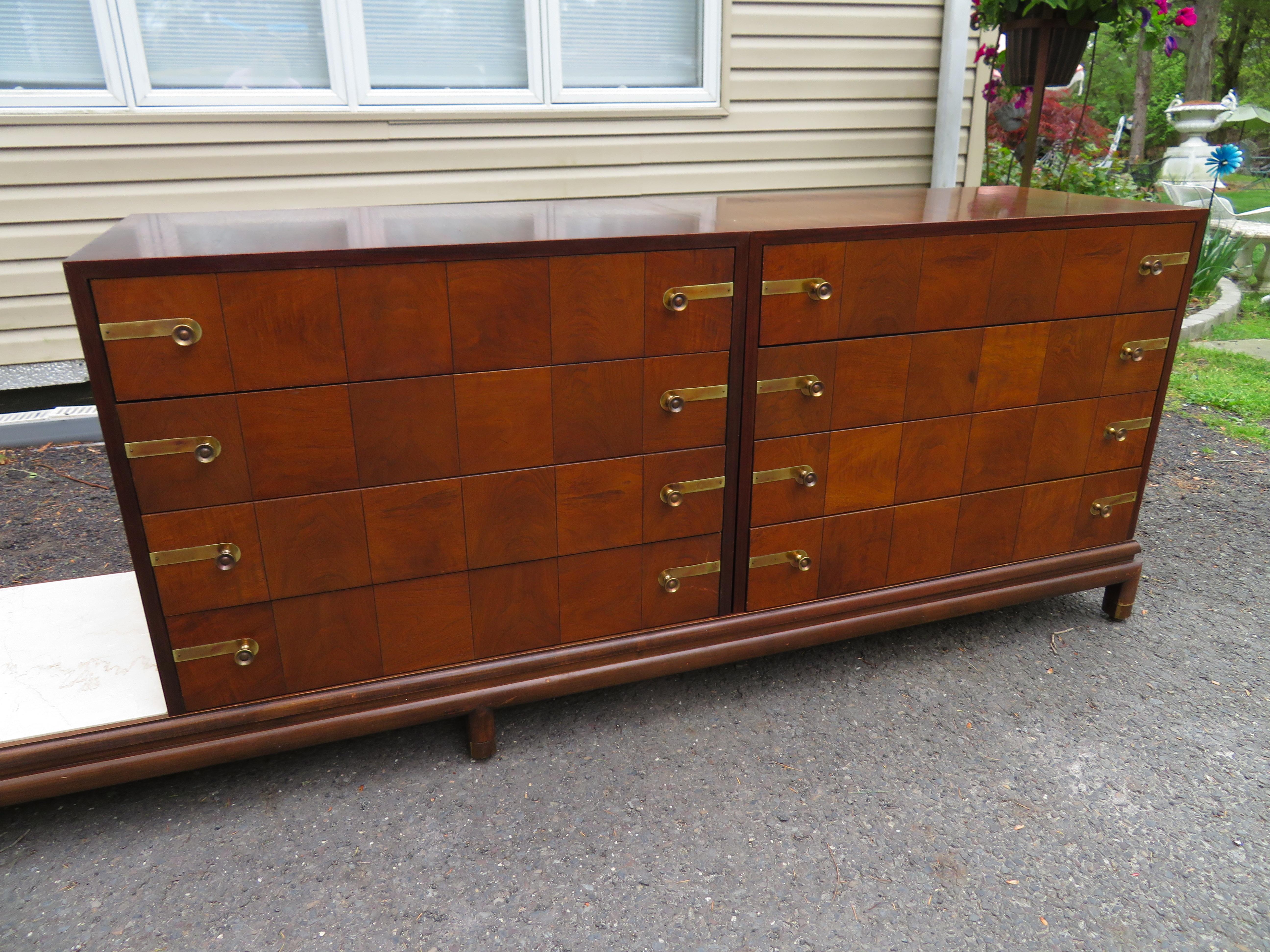 Rare Mid-Century Modern 3-part chest or credenza designed by Renzo Rutili (Lorenzo R. Rutili American 1901-1966) for Johnson Furniture Co. Set of 2 walnut cases with 4 drawers each and 1 travertine shelf. The chests are mounted on a long Asian