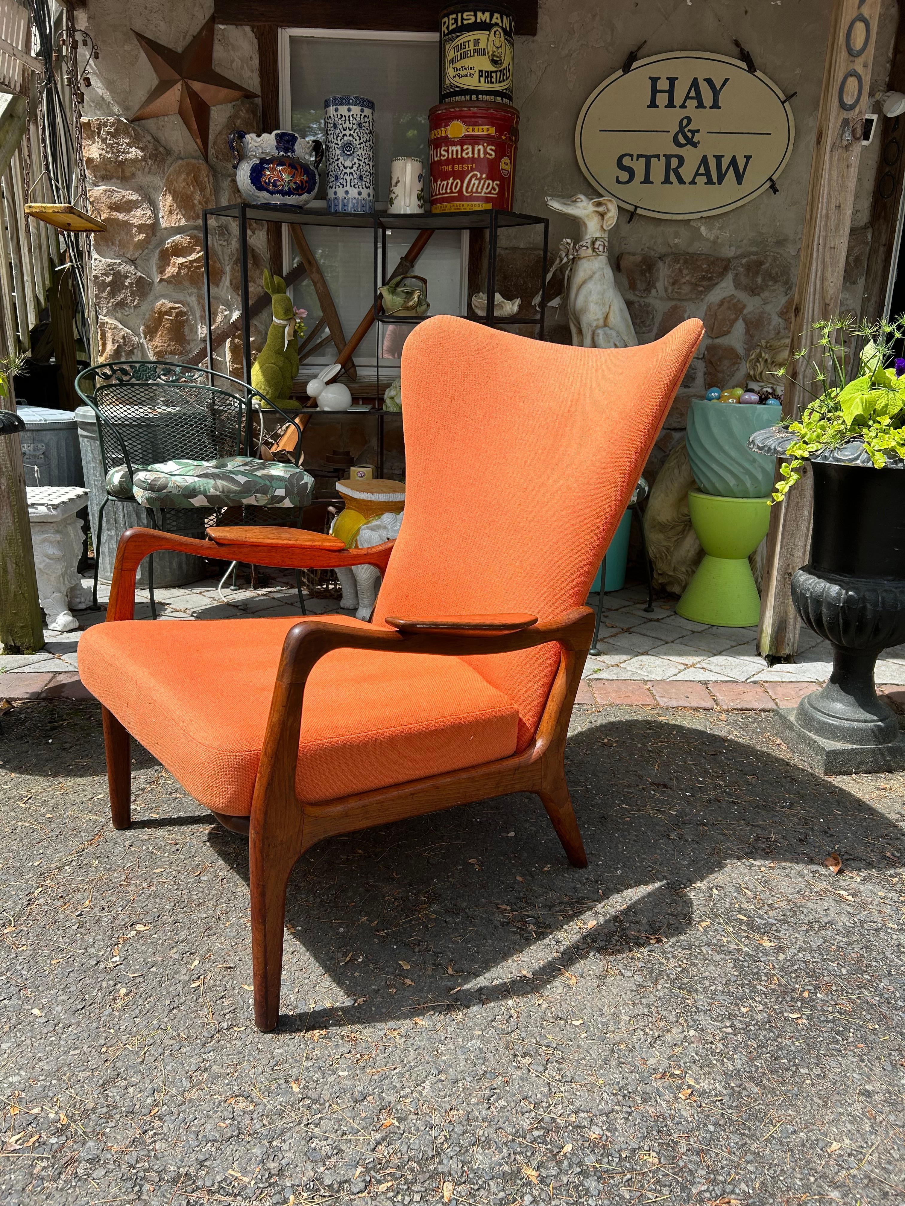 Stylish Adrian Pearsall sculptural walnut wing back chair.  The original tangerine orange wool upholstery looks presentable with only some light wear-cleaning recommended.  The rubber straps look newer and still work great.  This chair measures 37