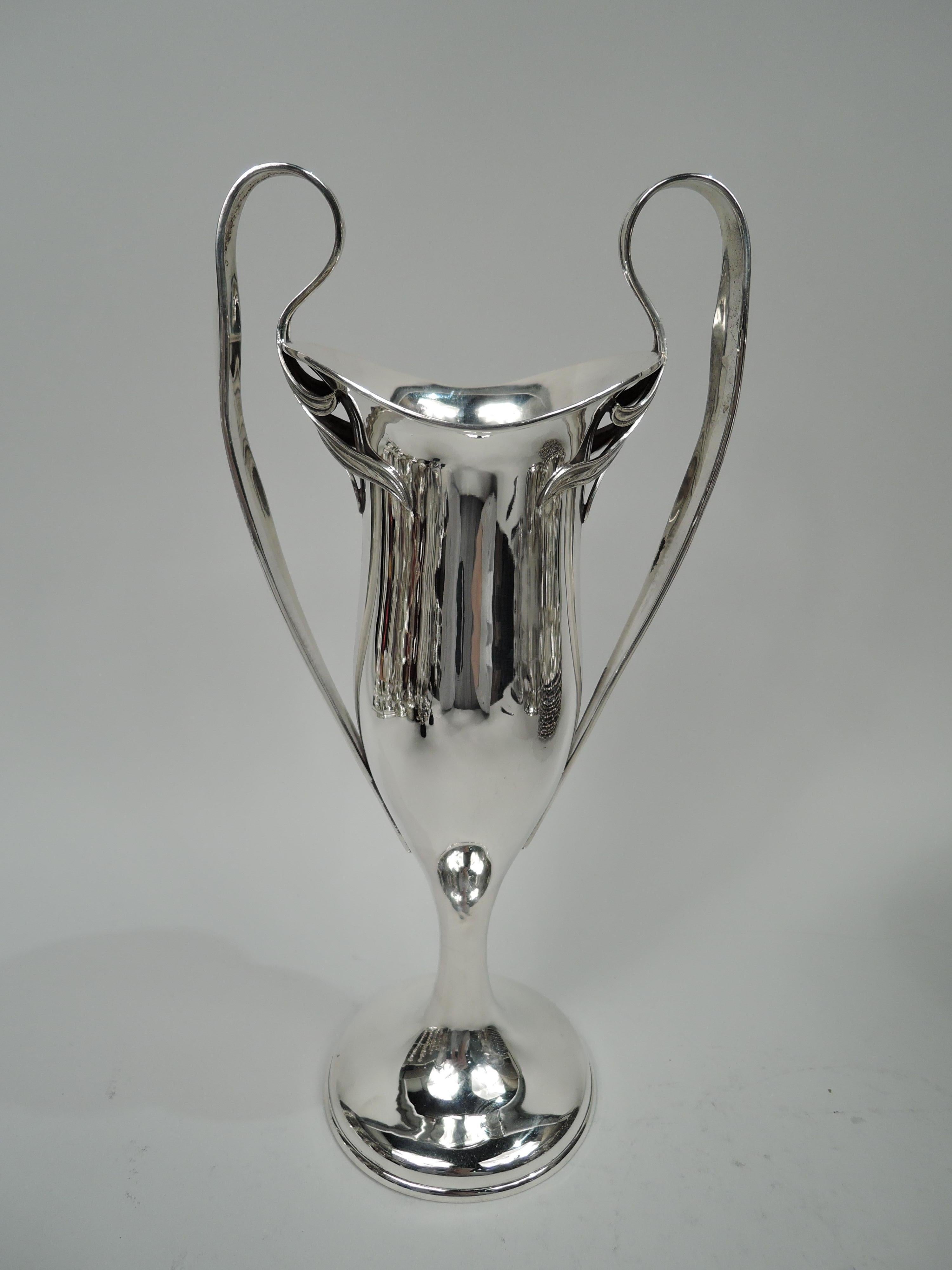 Stylish turn-of-the-century Art Nouveau sterling silver vase. Made by Barbour Silver Co. (part of International Silver Co.) in Hartford. Tall and elongated body with swooping asymmetrical mouth flowing into cylindrical support on domed foot.