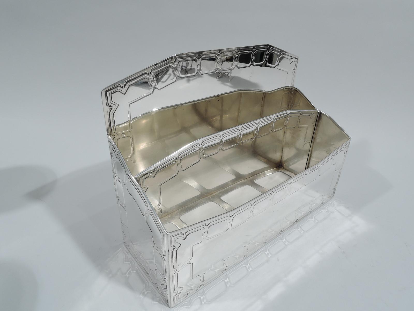 Modern sterling silver letter rack. Made by Tiffany & Co. in New York, ca 1908. Rectilinear with 3 graduated partitions mounted to open rectangular base. Back and central partition chamfered. Side rims scalloped. Two compartments can be converted to